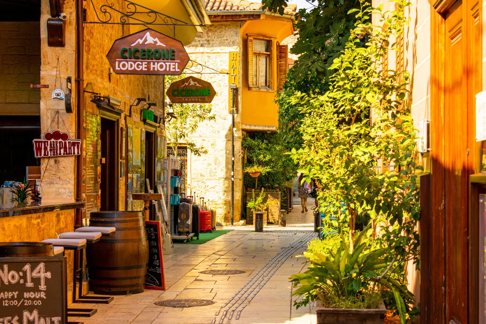 Explore a picturesque narrow street in Antalya, Türkiye, lined with cafes and boutiques.