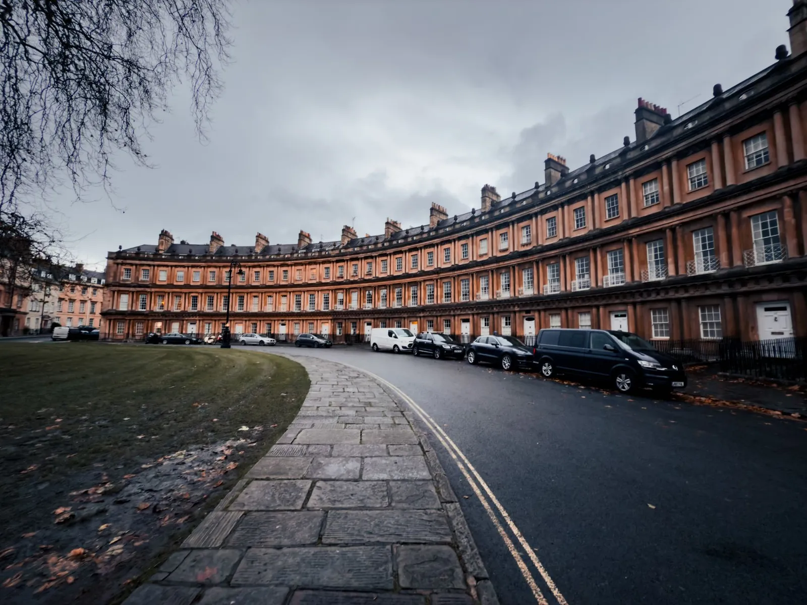Capturing the classic Georgian architecture of the Circus in Bath, England, on a cloudy day.