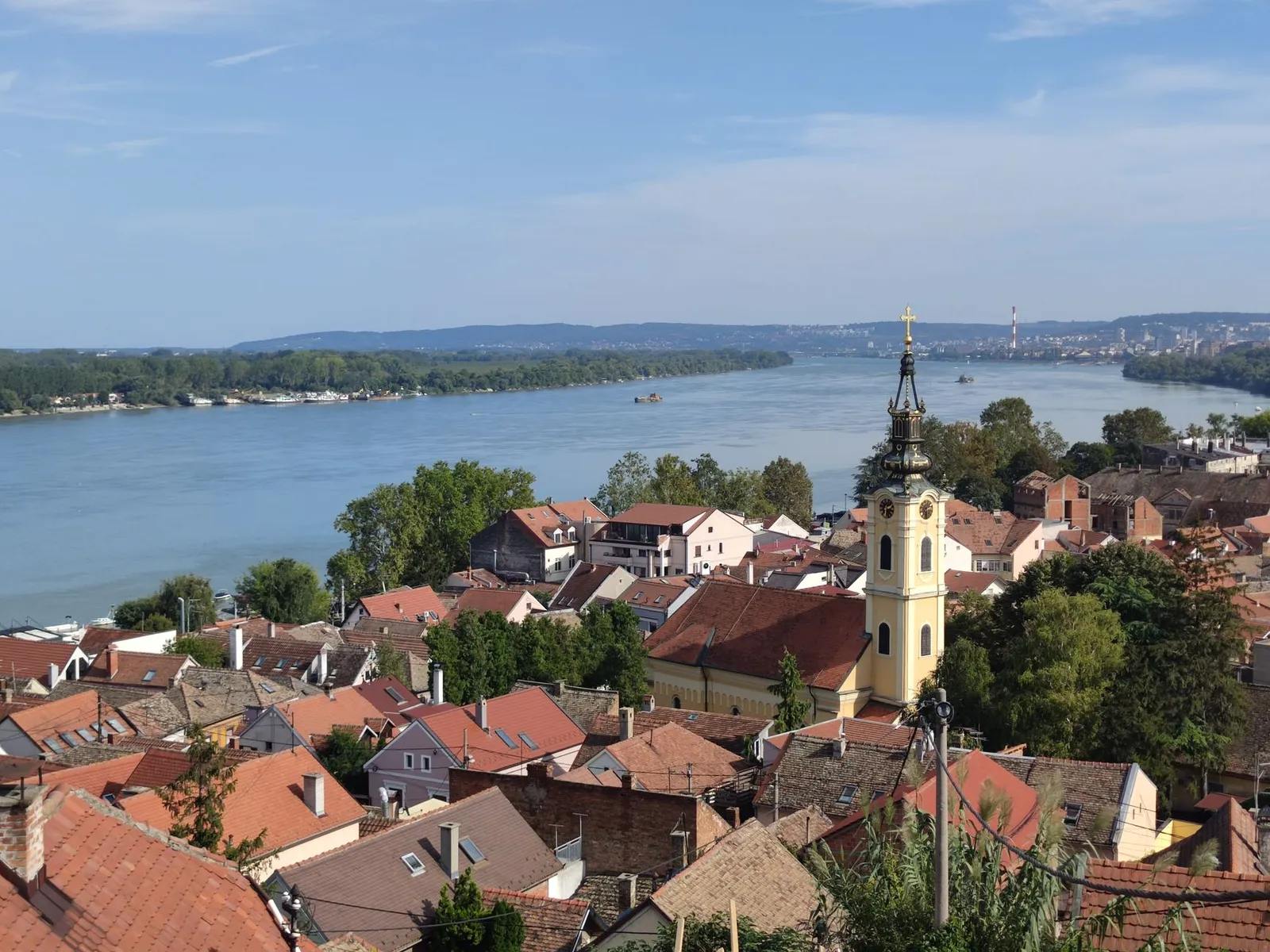 Beautiful aerial view of Zemun, Serbia with the Danube River and historic church tower.