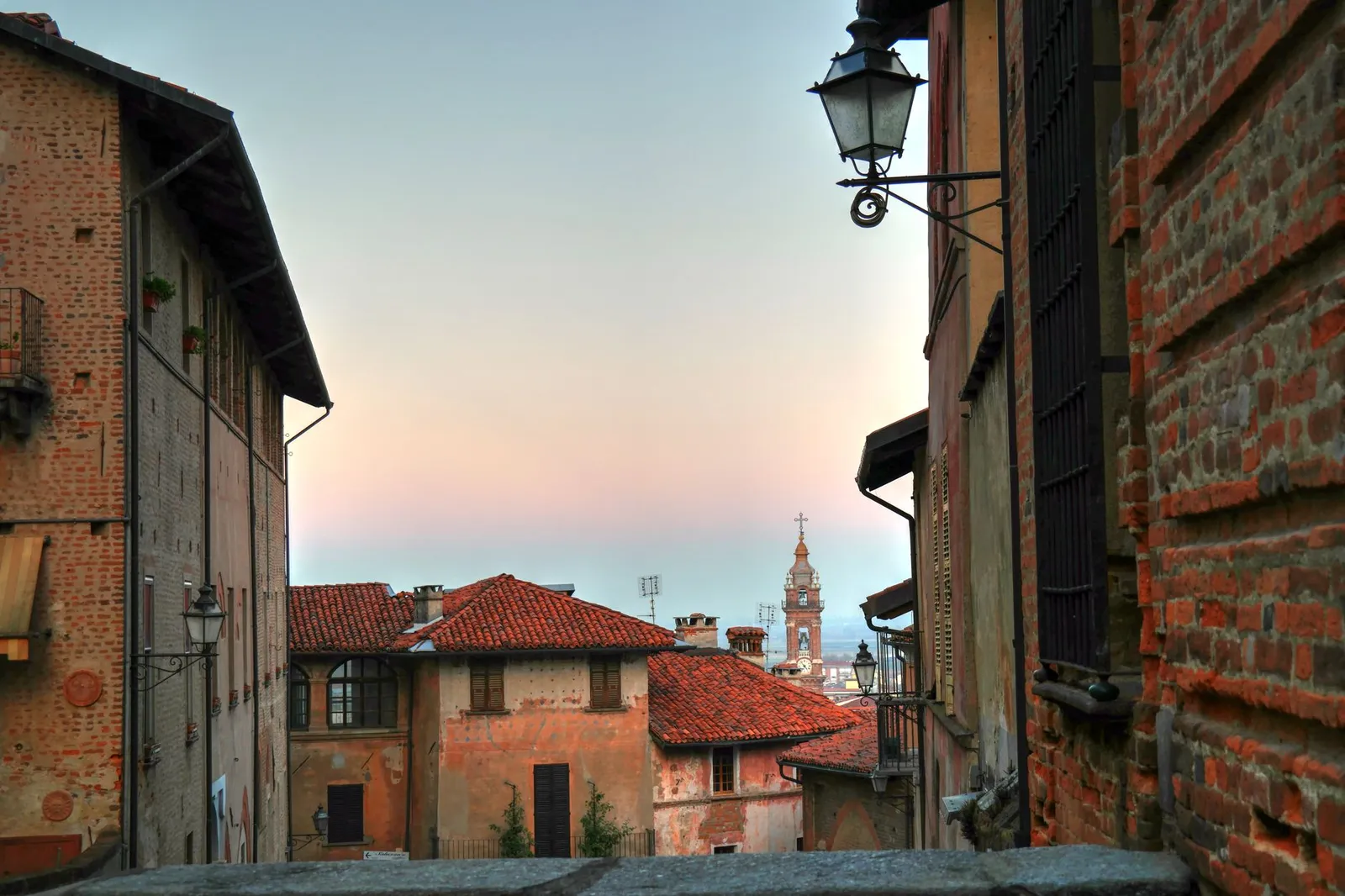Enchanting sunset over historic Saluzzo, Italy, showcasing traditional architecture and serene streets.