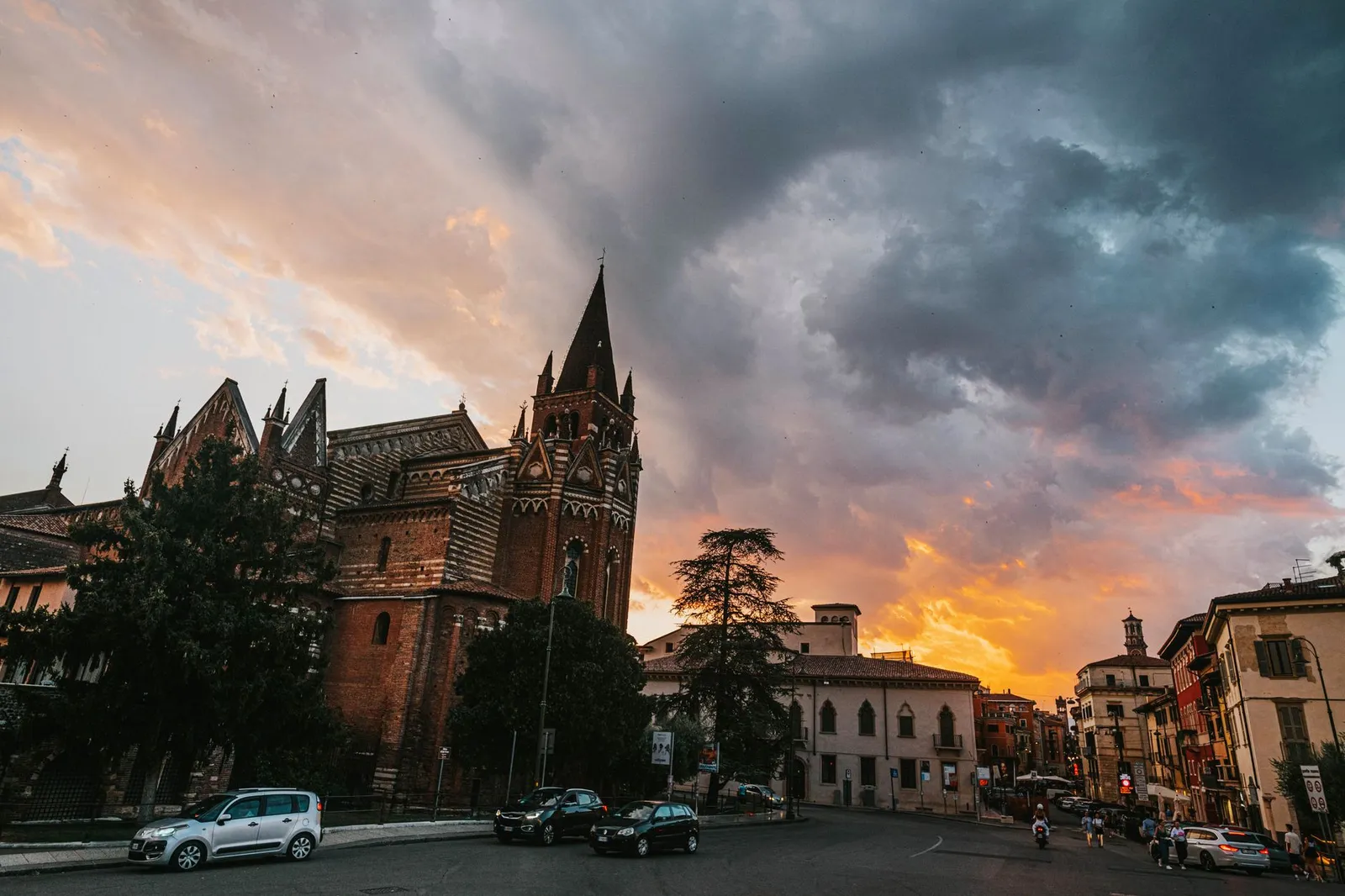 The stunning San Fermo Maggiore church in Verona, Italy against a dramatic sunset sky.