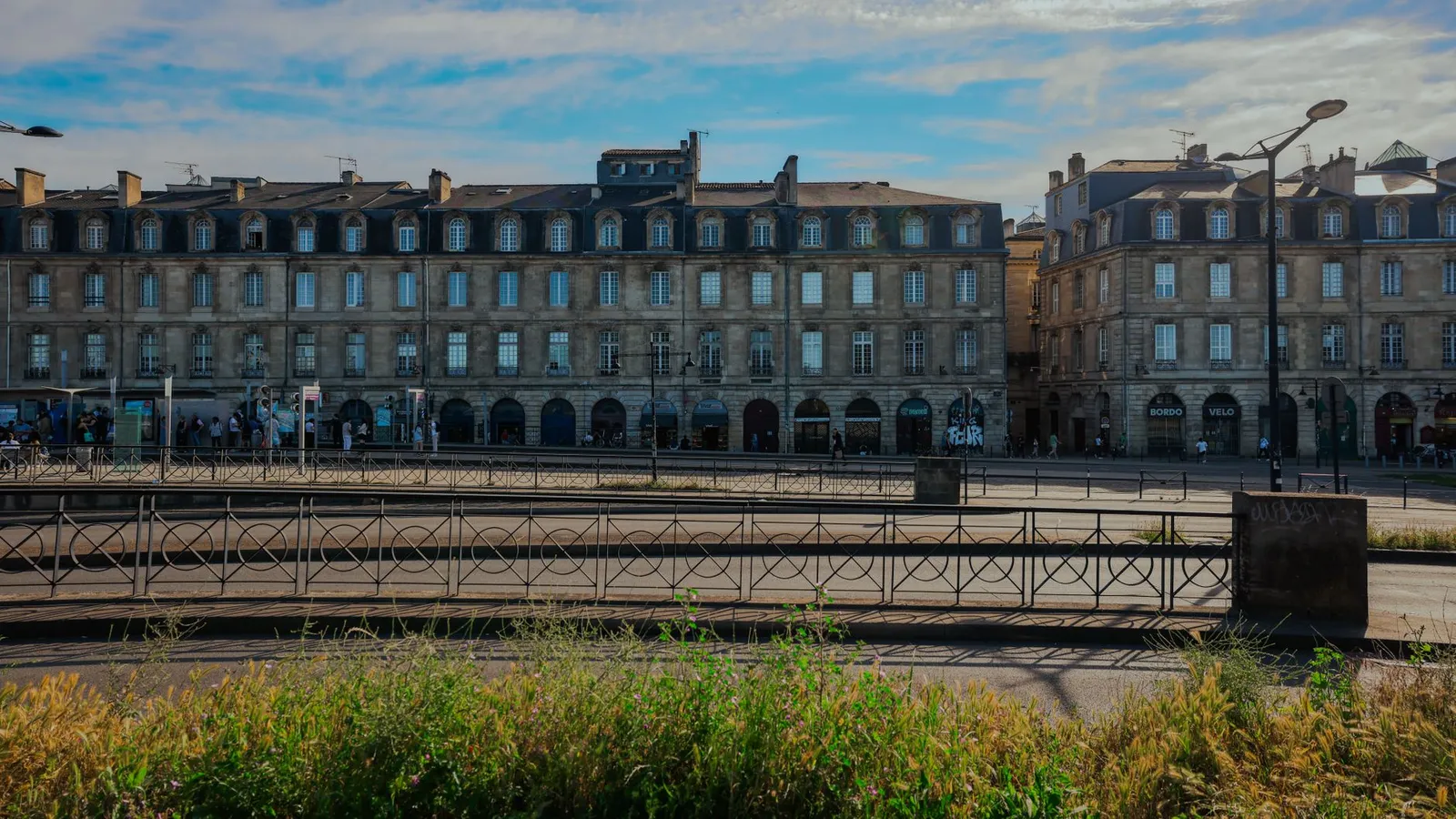 Elegant historic buildings in Bordeaux, France under a clear blue sky.