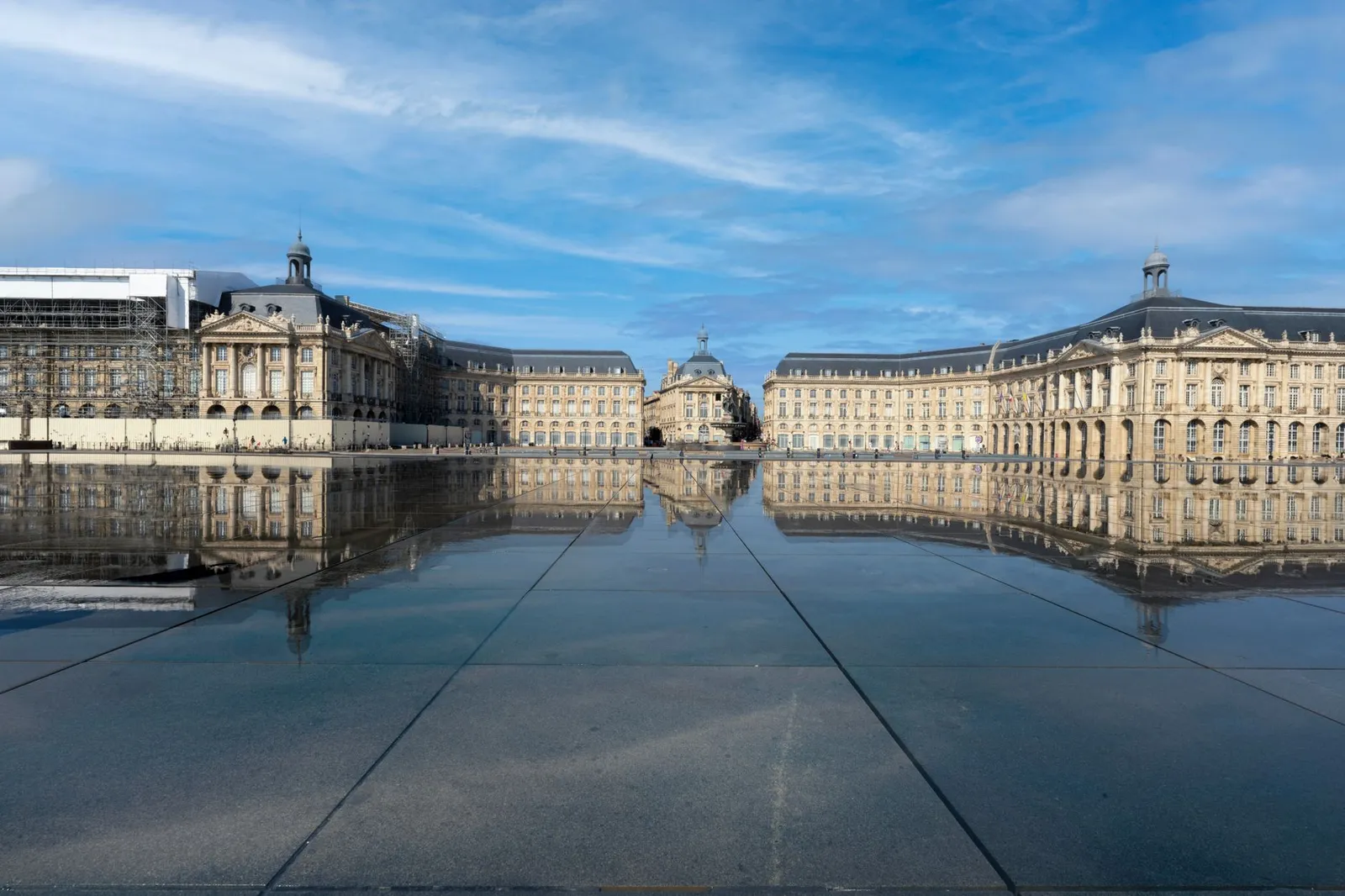 Stunning neoclassical architecture of Place de la Bourse reflected on a calm water surface in Bordeaux, France.