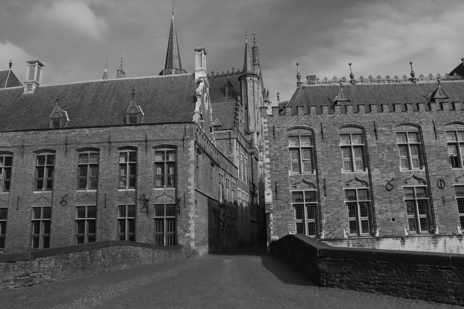 Explore the Gothic charm of Bruges with this black and white photograph of medieval architecture.