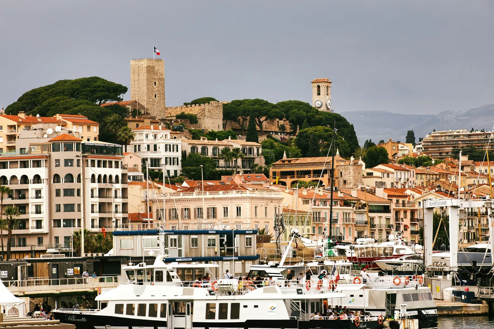 Beautiful harbor scene in Cannes showcasing historic buildings and vibrant waterfront activities.