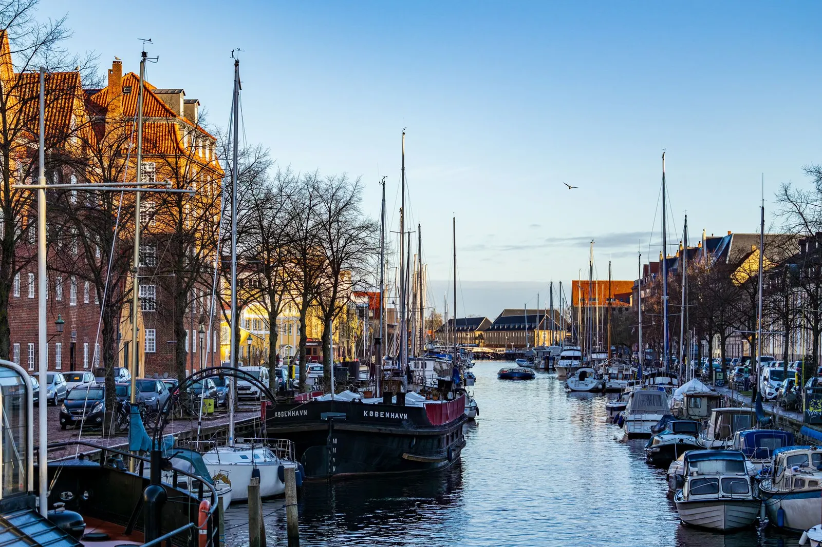 Colorful canal with boats in Christianshavn, Copenhagen captured on a sunny winter day.