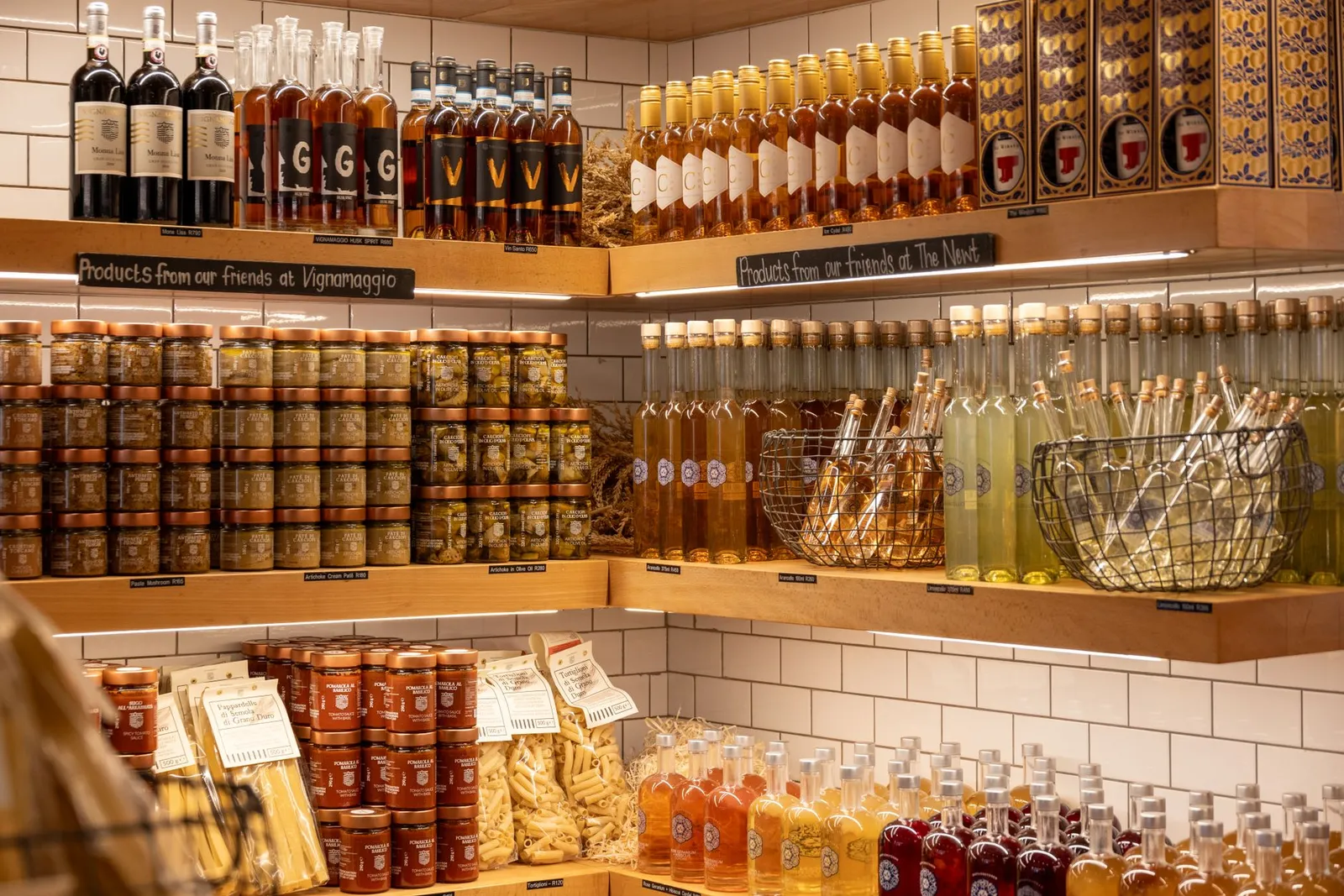 A vibrant display of Italian wines, spirits, and gourmet products in a rustic store setting.
