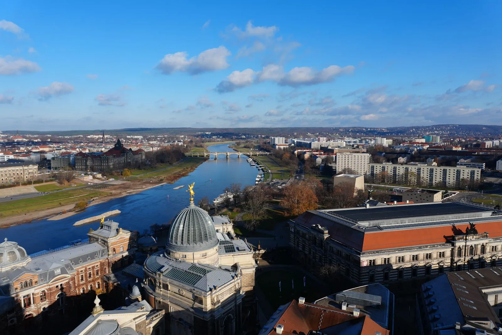 Stunning aerial view of Dresden showing historic architecture and the Elbe River under a clear blue sky.