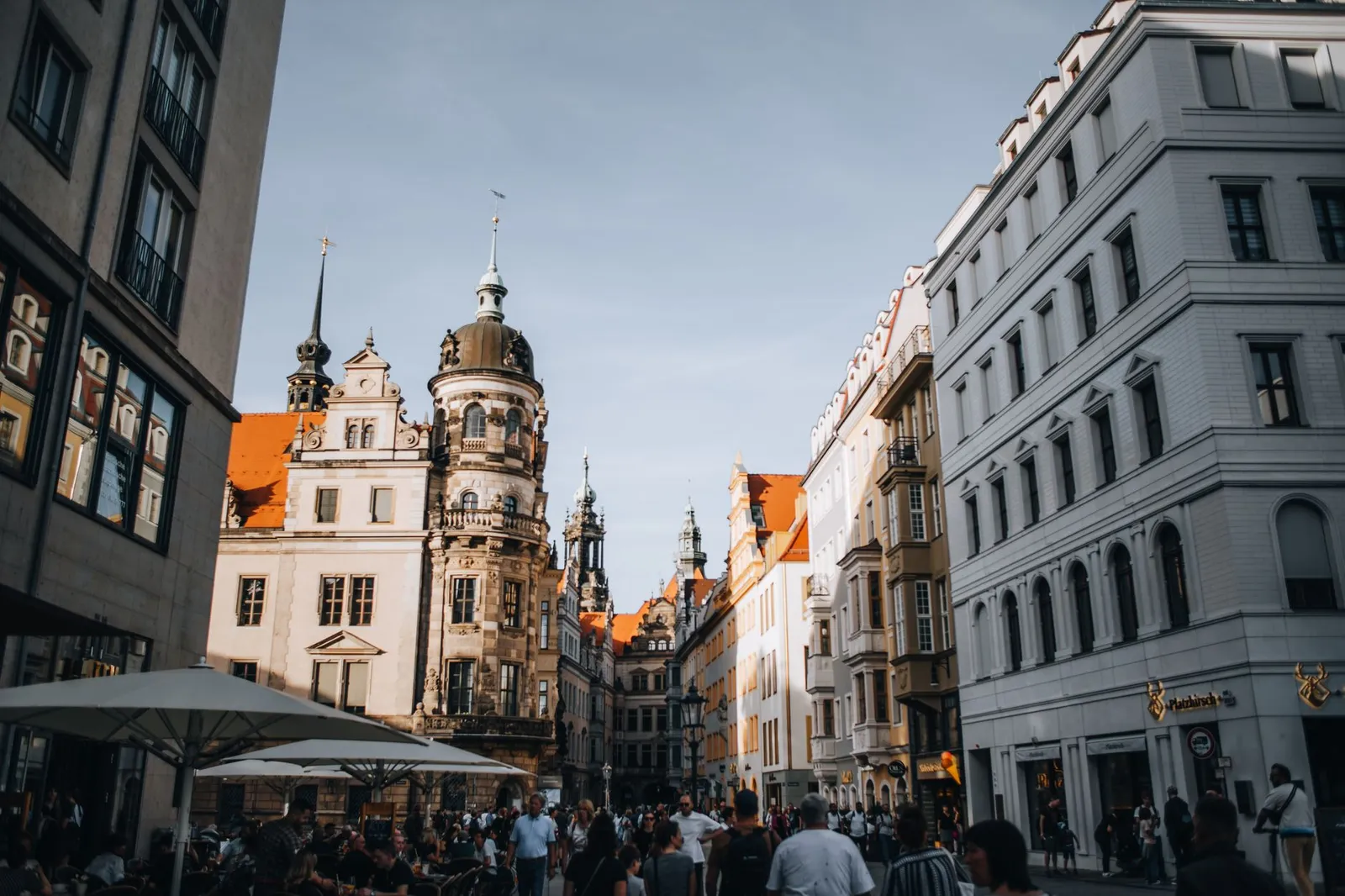 Crowds enjoy a vibrant day in the historic streets of Dresden's old town.