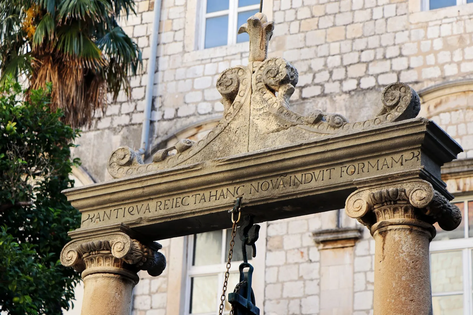 Elegant historical detail from Dubrovnik's Old Town, highlighting classic limestone architecture and Latin inscriptions.