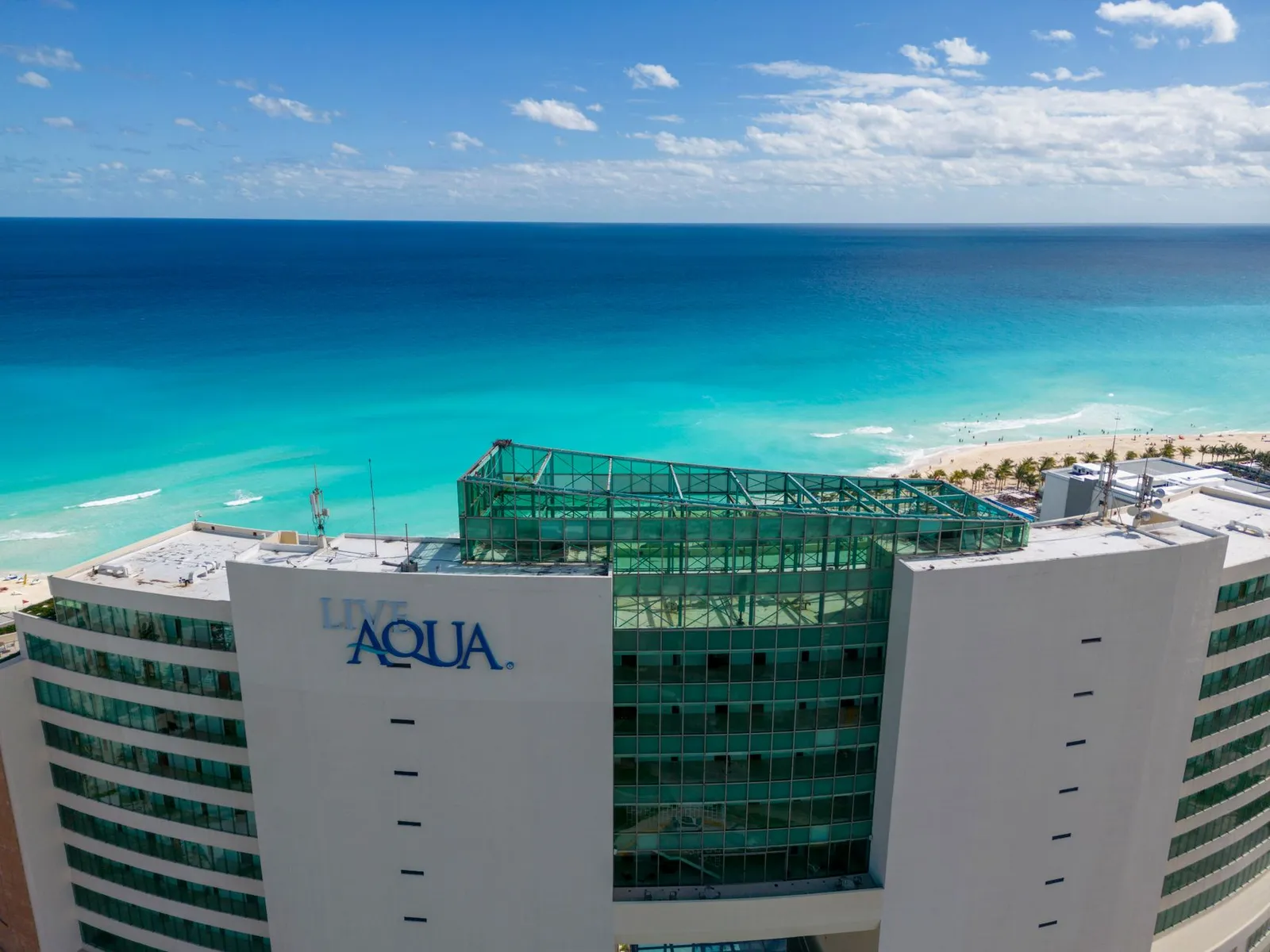 A stunning aerial view of Live Aqua Resort with turquoise sea in Cancun's hotel zone.