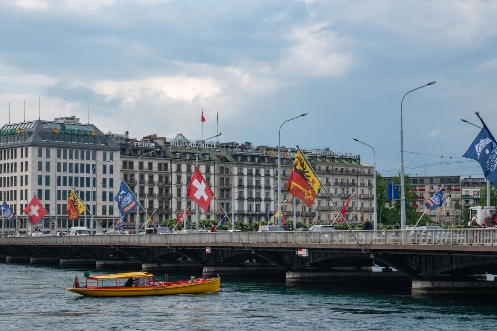 Capture of Mont-Blanc Bridge with flags and cityscape in Geneva, Switzerland.