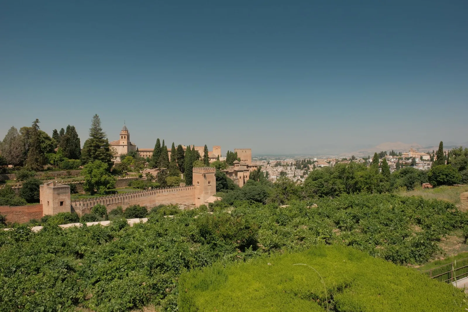 Explore the stunning Alhambra, Granada with this panoramic view under the bright Spanish sun.