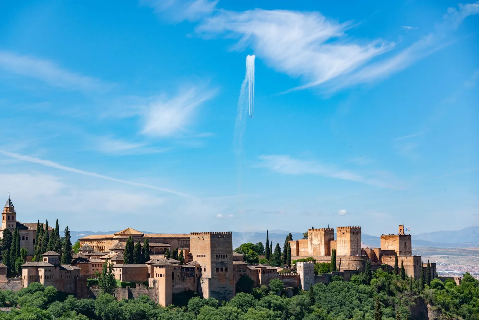 Stunning view of the Alhambra Palace set against a clear blue sky in Granada, Spain.