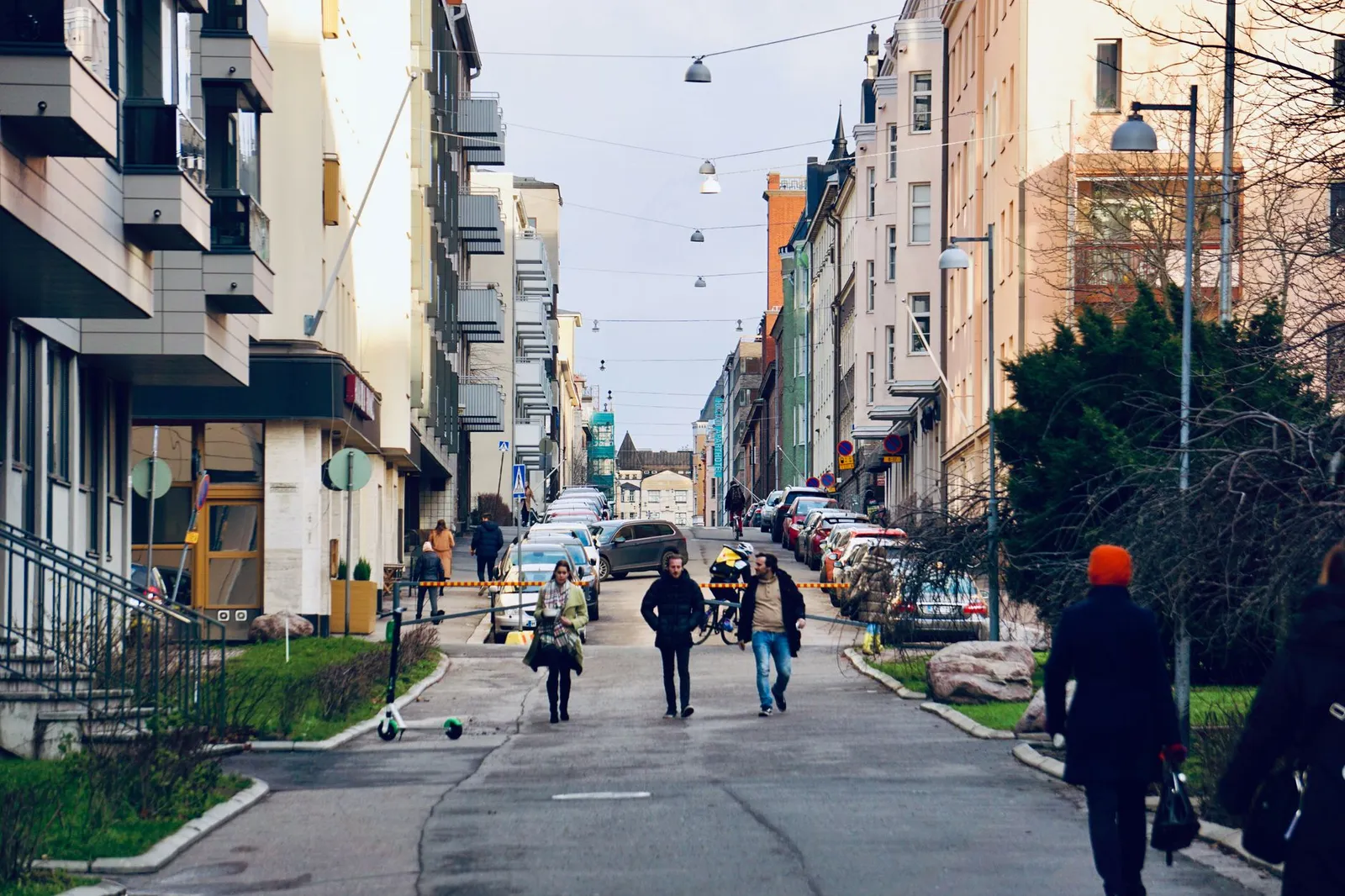 Vibrant street scene in Helsinki, Finland, showcasing pedestrians amidst urban architecture.