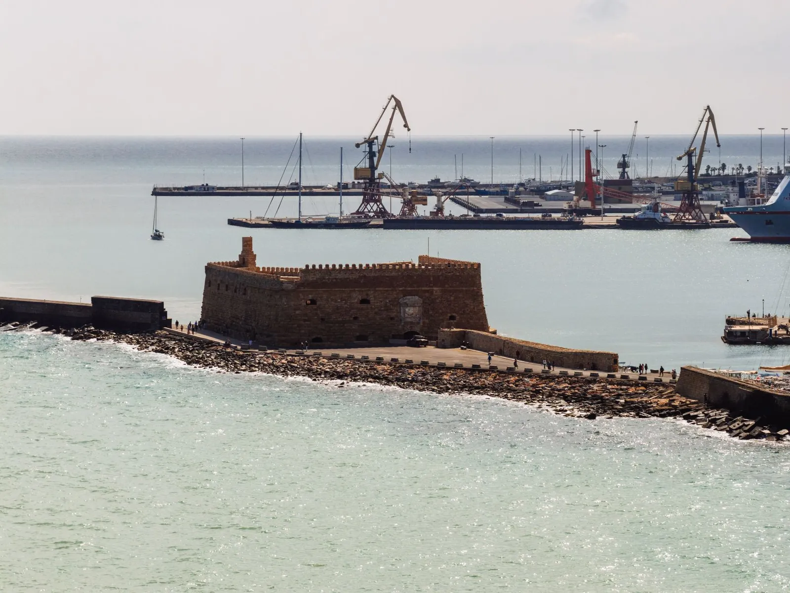 Aerial view of the historic Venetian Fort and harbor cranes in Heraklion, Crete, Greece.