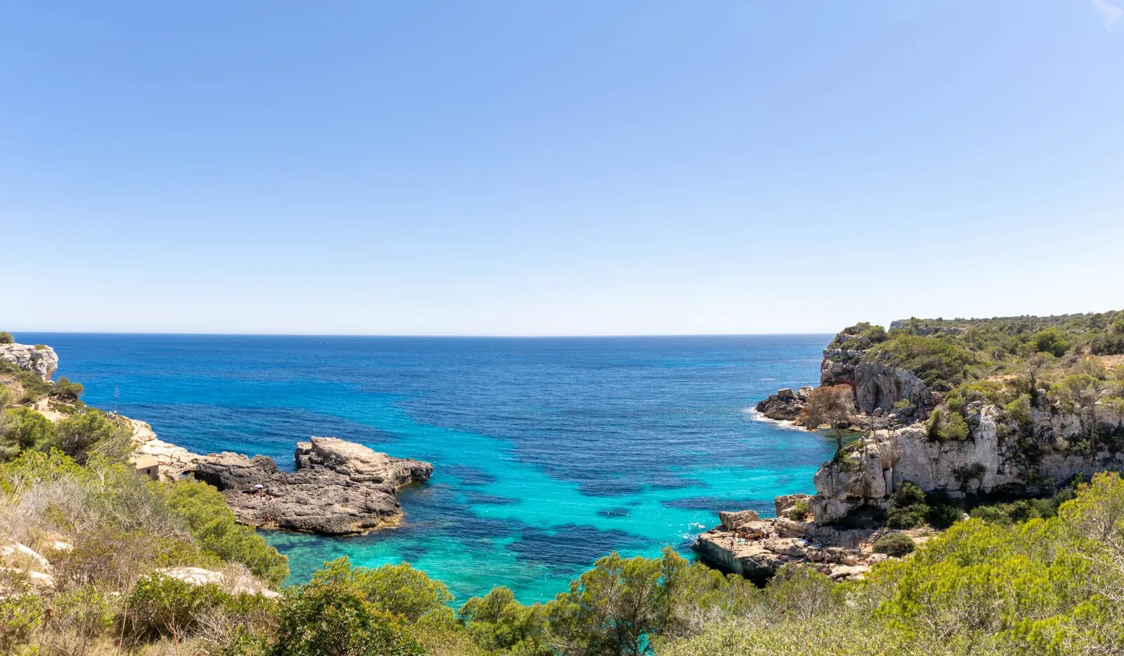 Breathtaking view of Sant Antoni de Portmany's turquoise sea and cliffs.