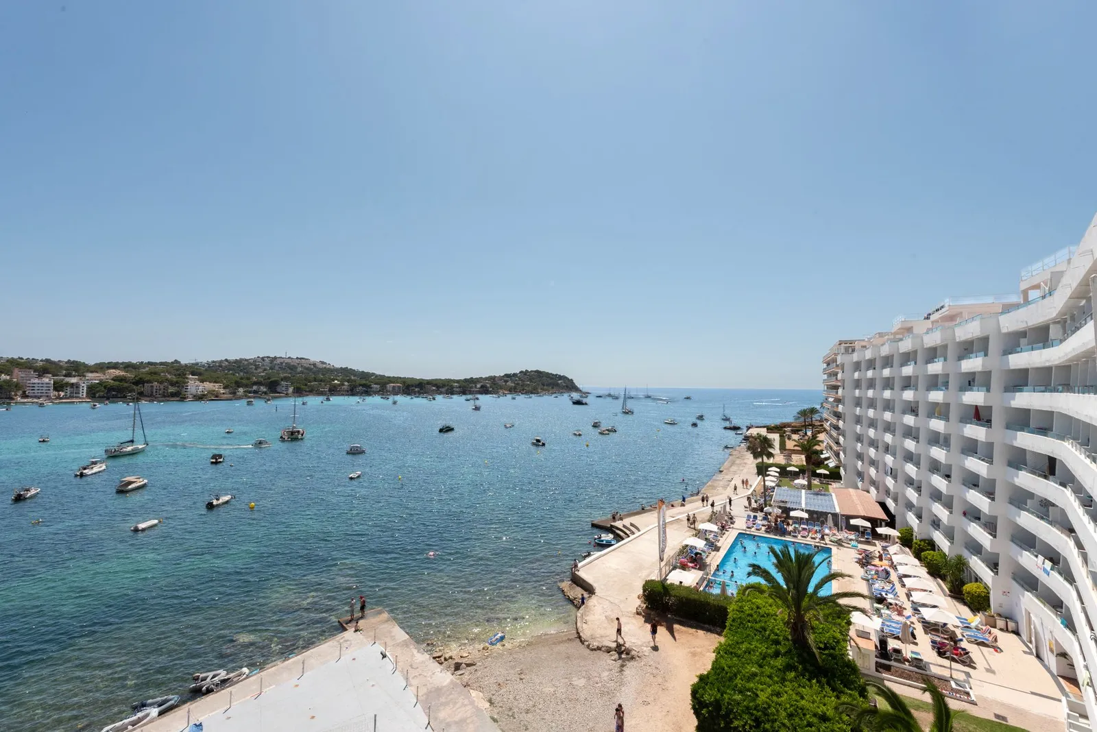 Aerial view of Santa Ponsa with beach, sea, and hotels during a sunny summer day.