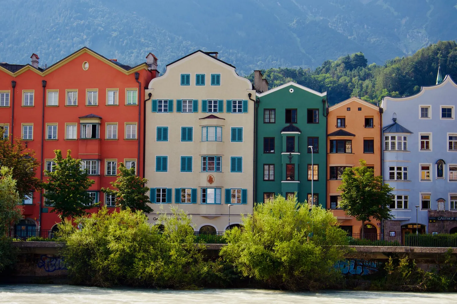 Vibrant facade of traditional houses by the river in Innsbruck, Tyrol, Austria.