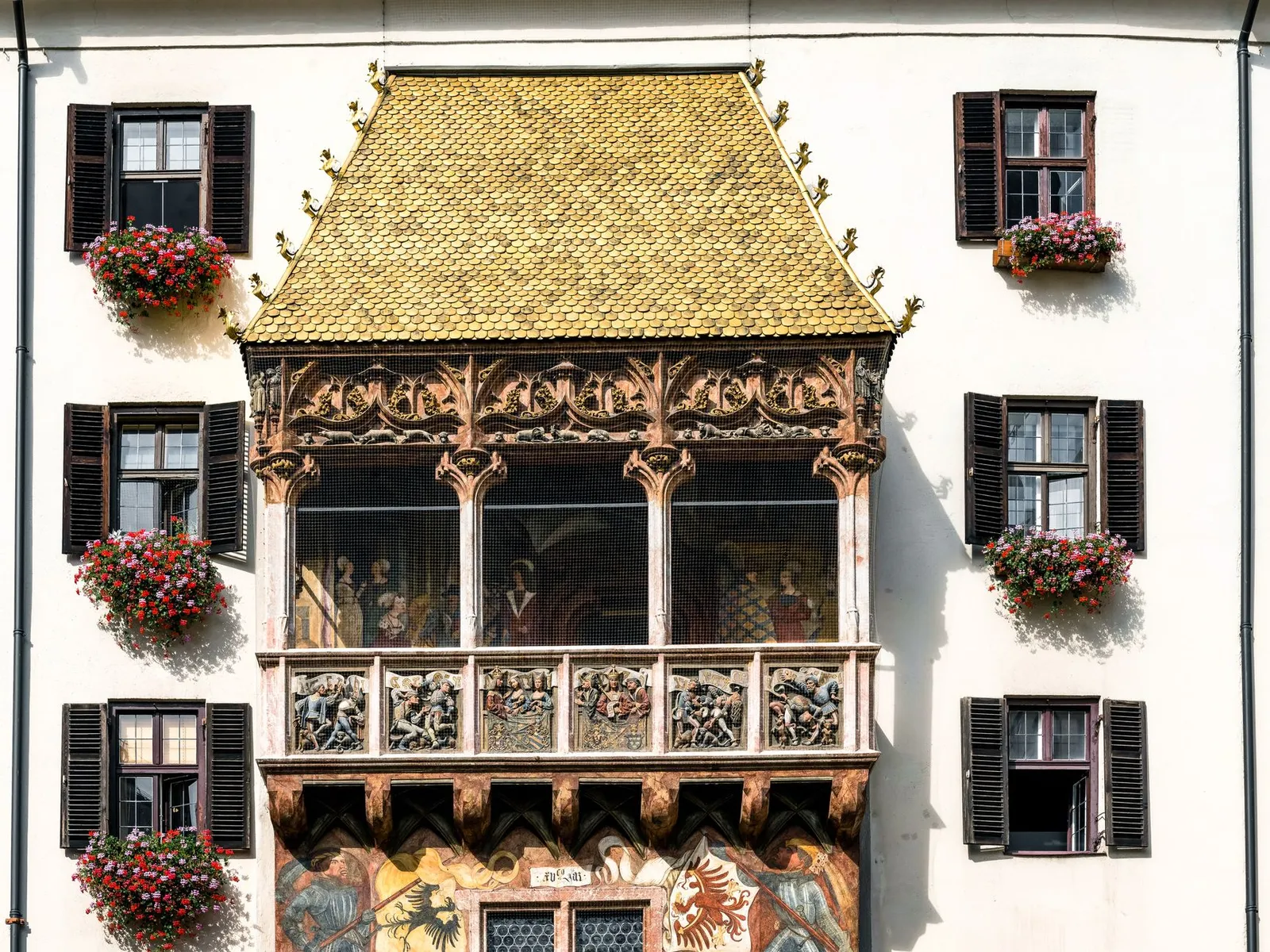 The historic Golden Roof in Innsbruck's old town, showcasing ornate architecture and floral decoration.