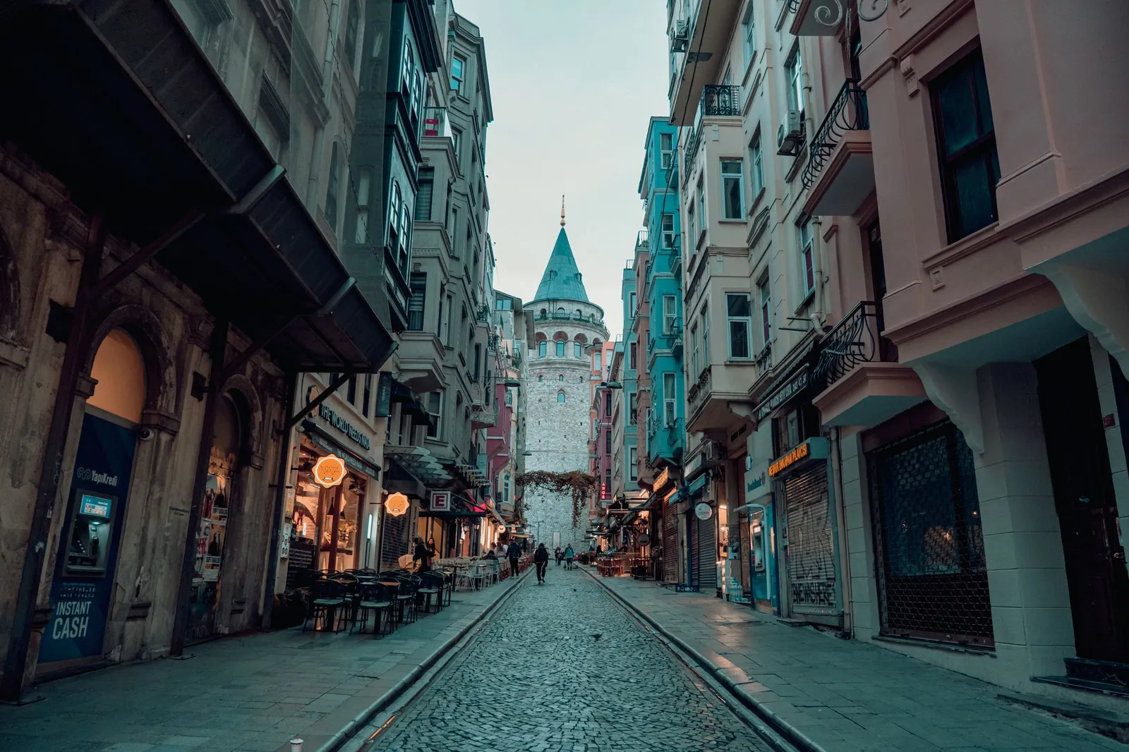 A picturesque view of a bustling street leading to the iconic Galata Tower in Istanbul.