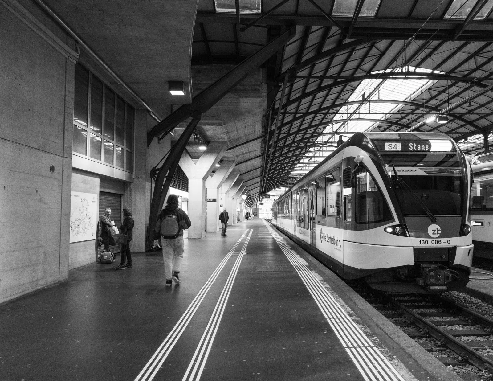 Train on platform in Lucerne station, Switzerland. Black and white urban scene.