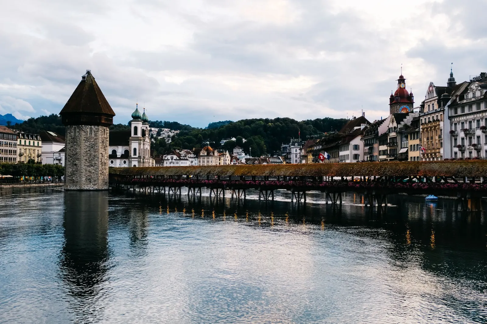 Beautiful view of the Chapel Bridge and Water Tower in Lucerne, reflecting on the Reuss River.