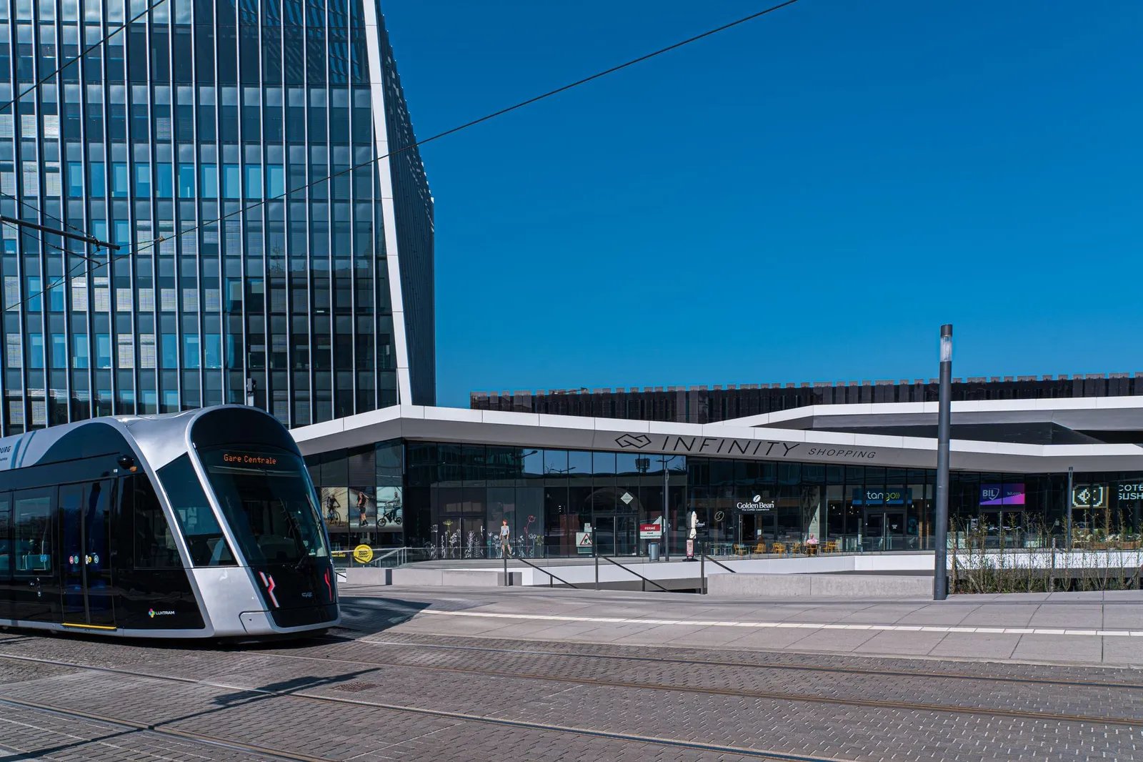Urban scene of modern tram and contemporary architecture in Kirchberg, Luxembourg.