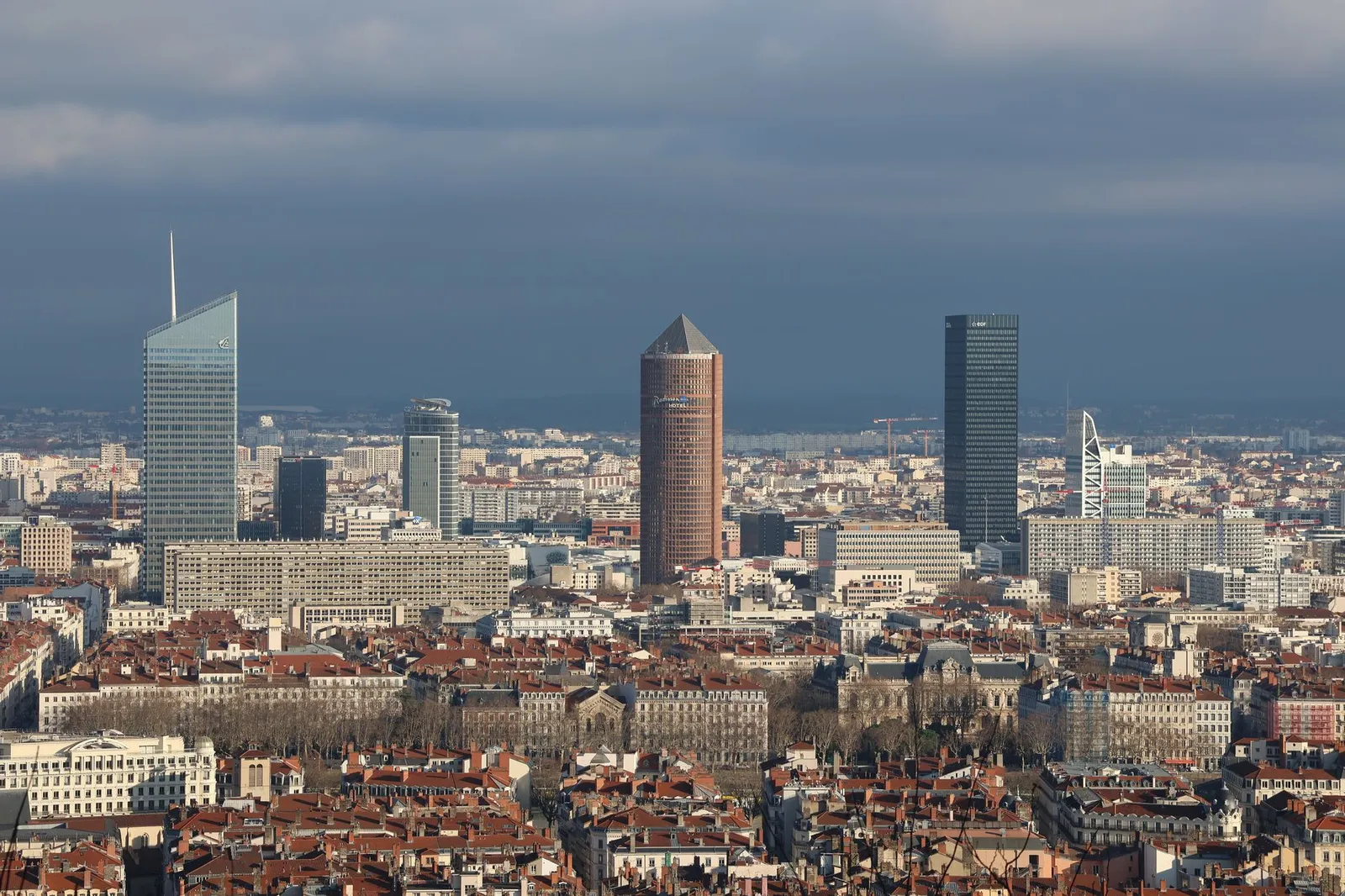 Aerial view of Lyon's skyline featuring modern skyscrapers and urban architecture.