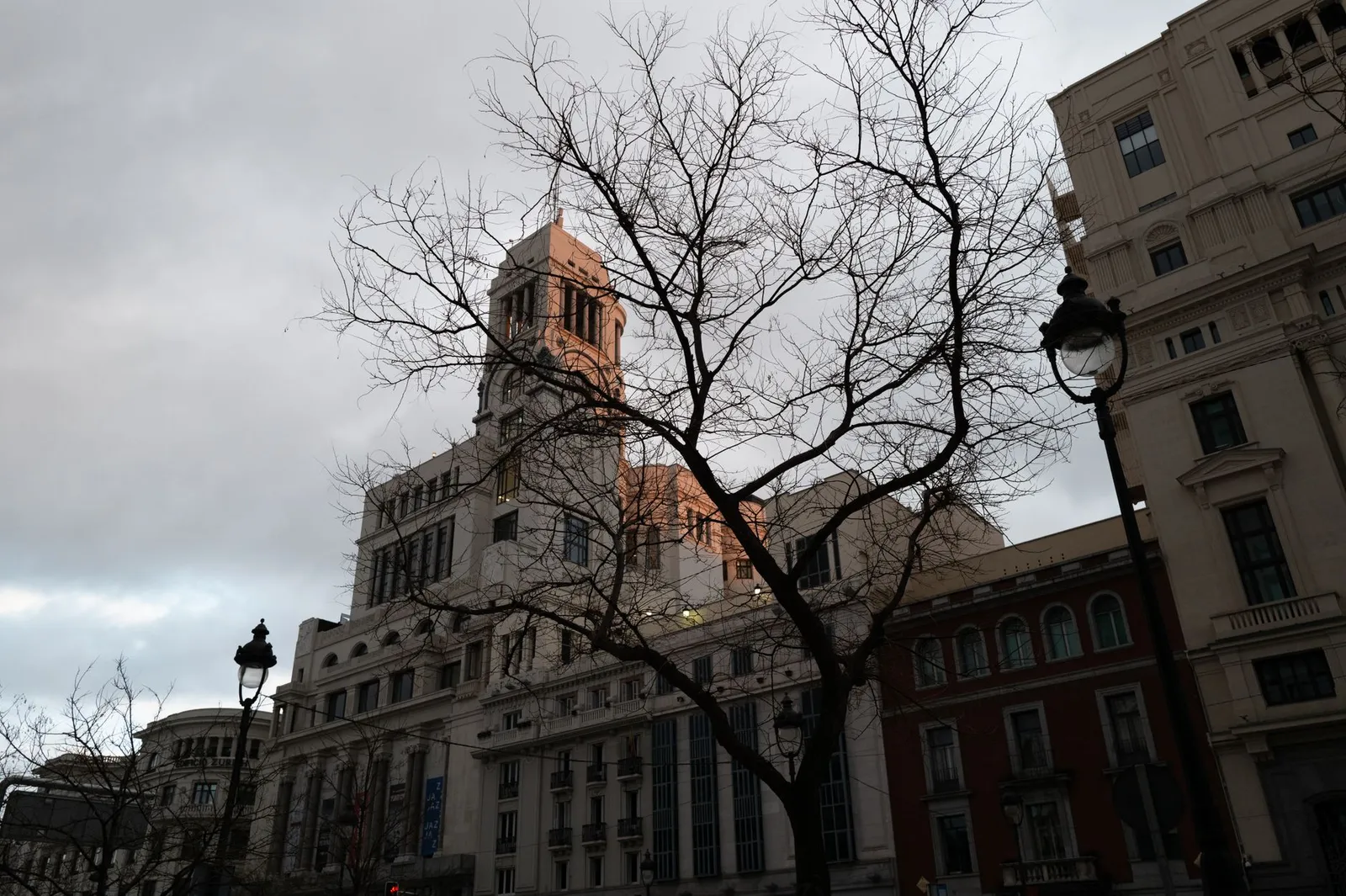 Dramatic skyline with historical architecture in Madrid during sunset.