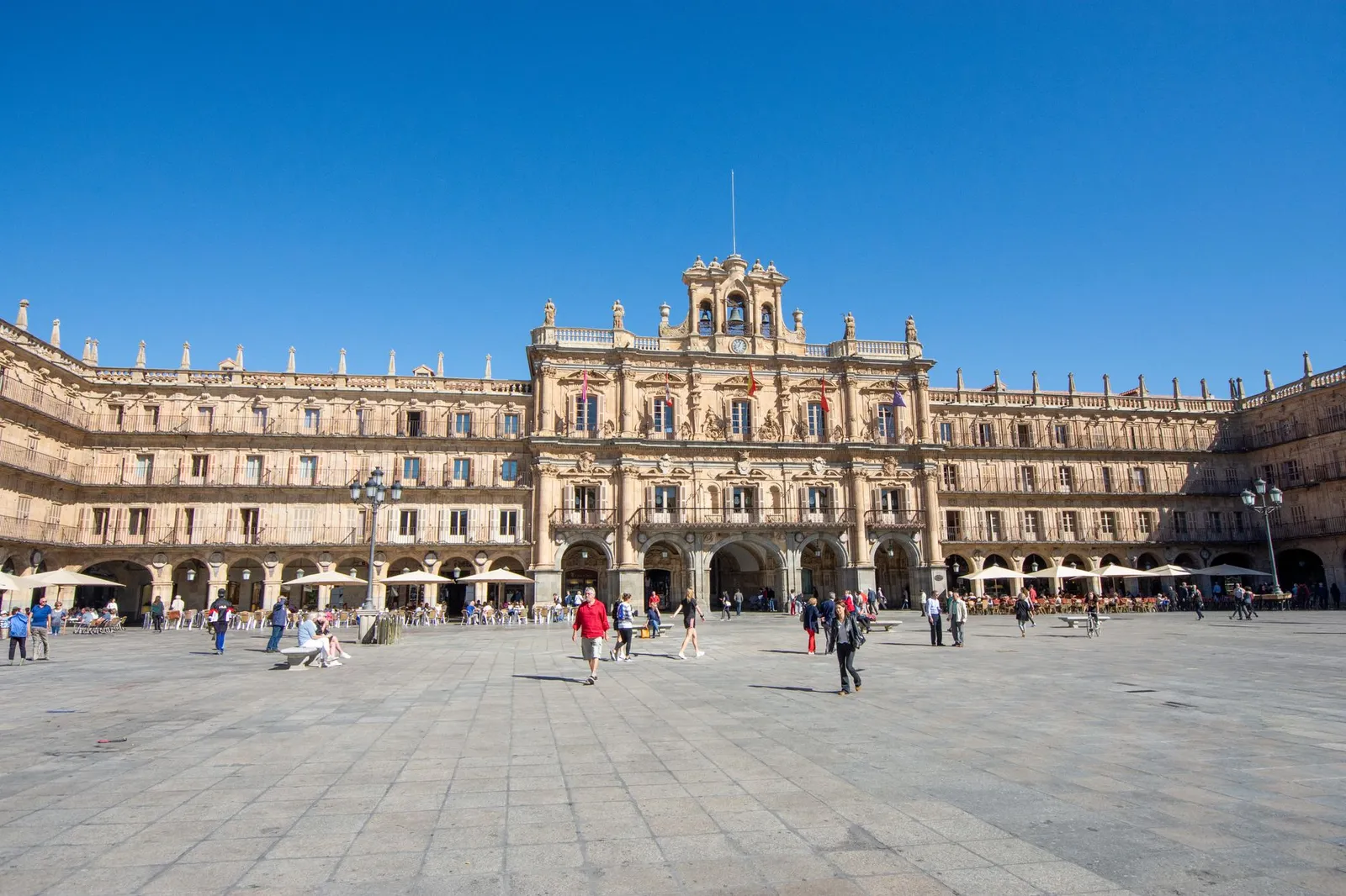 A bustling scene at Plaza Mayor in Salamanca, Spain, with people enjoying the vibrant atmosphere.