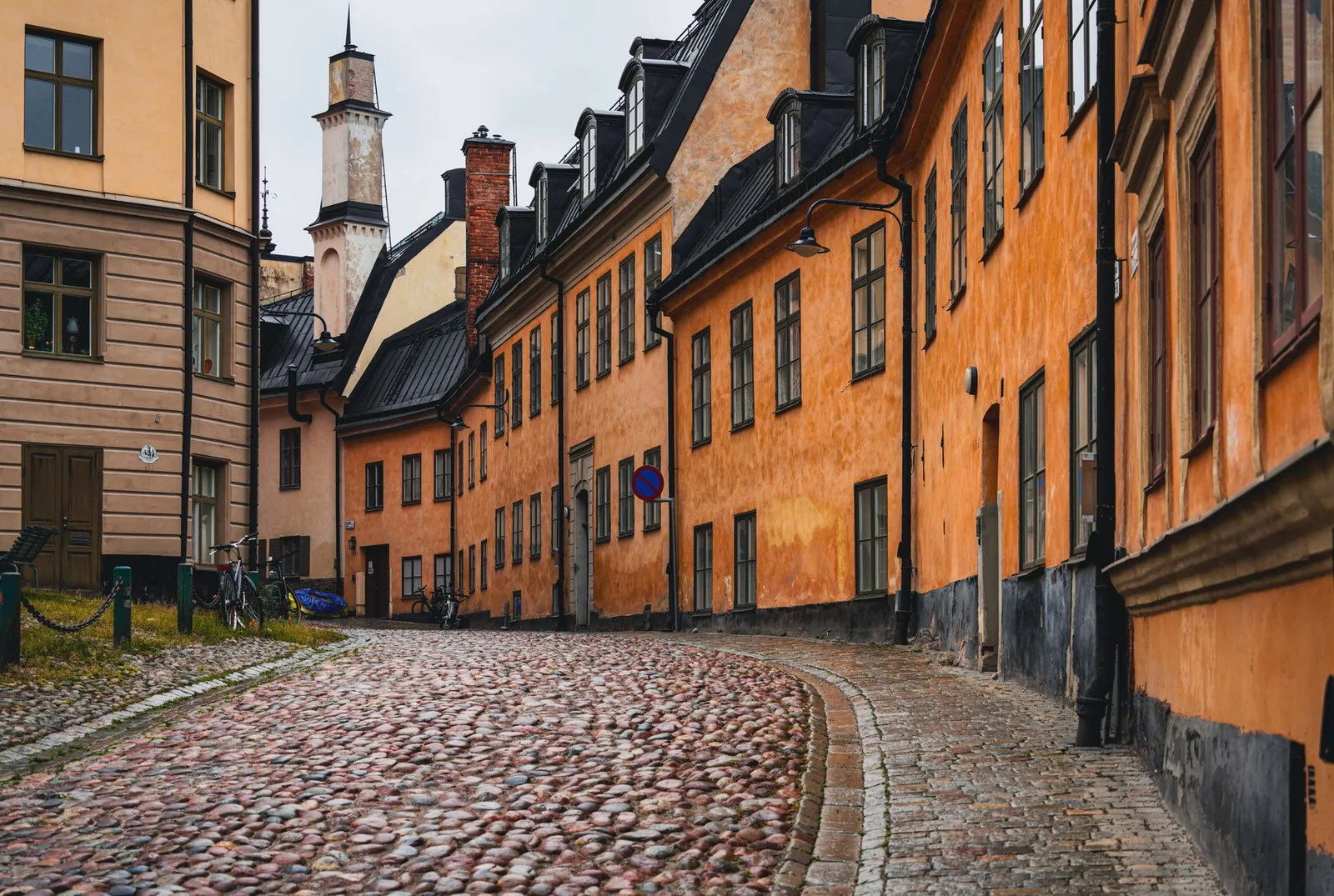 Beautiful narrow street lined with colorful historic buildings in Gamla Stan, Stockholm.