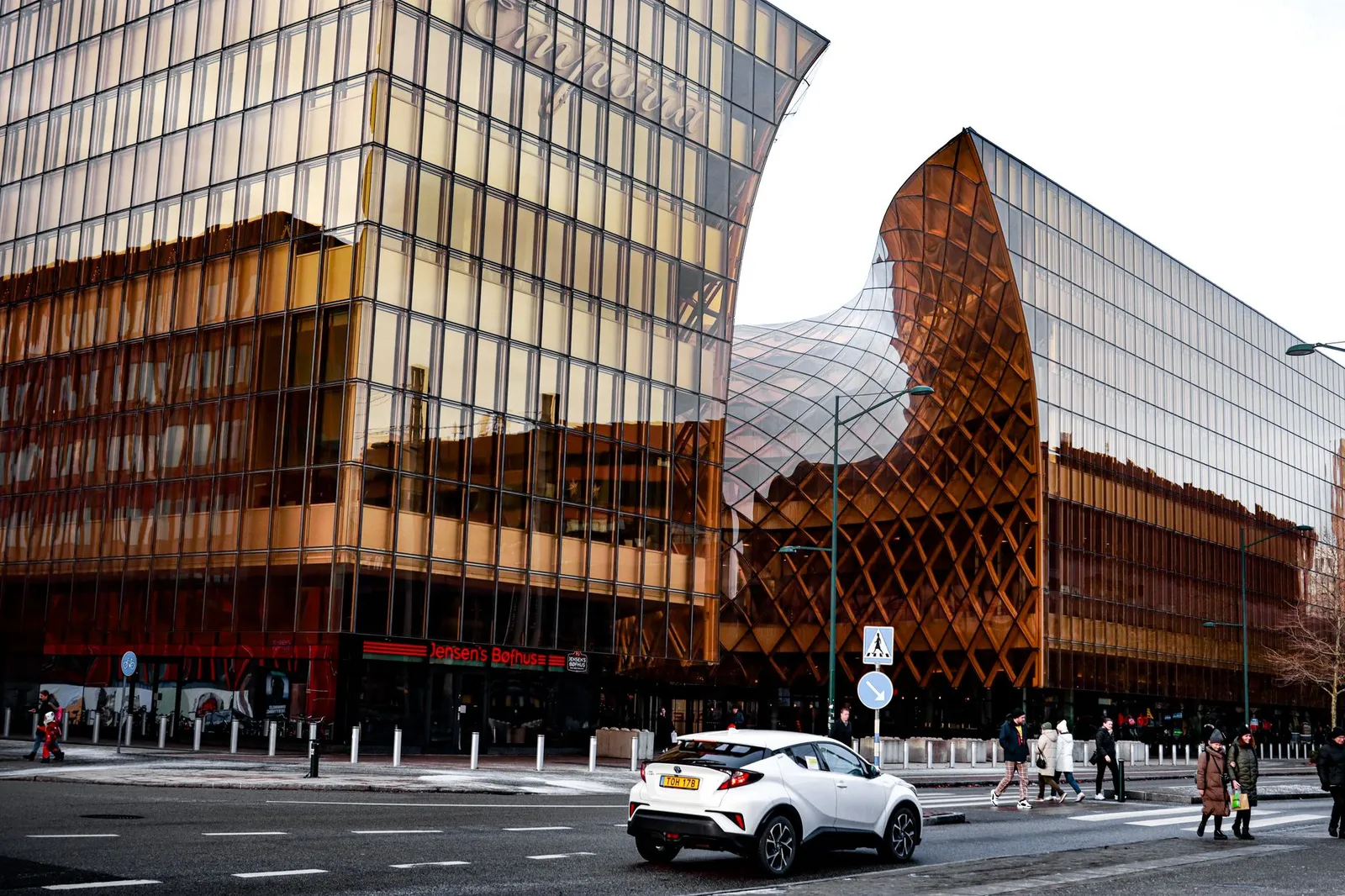 Stunning modern architecture in Malmö, showcasing glass reflections in a vibrant urban setting.