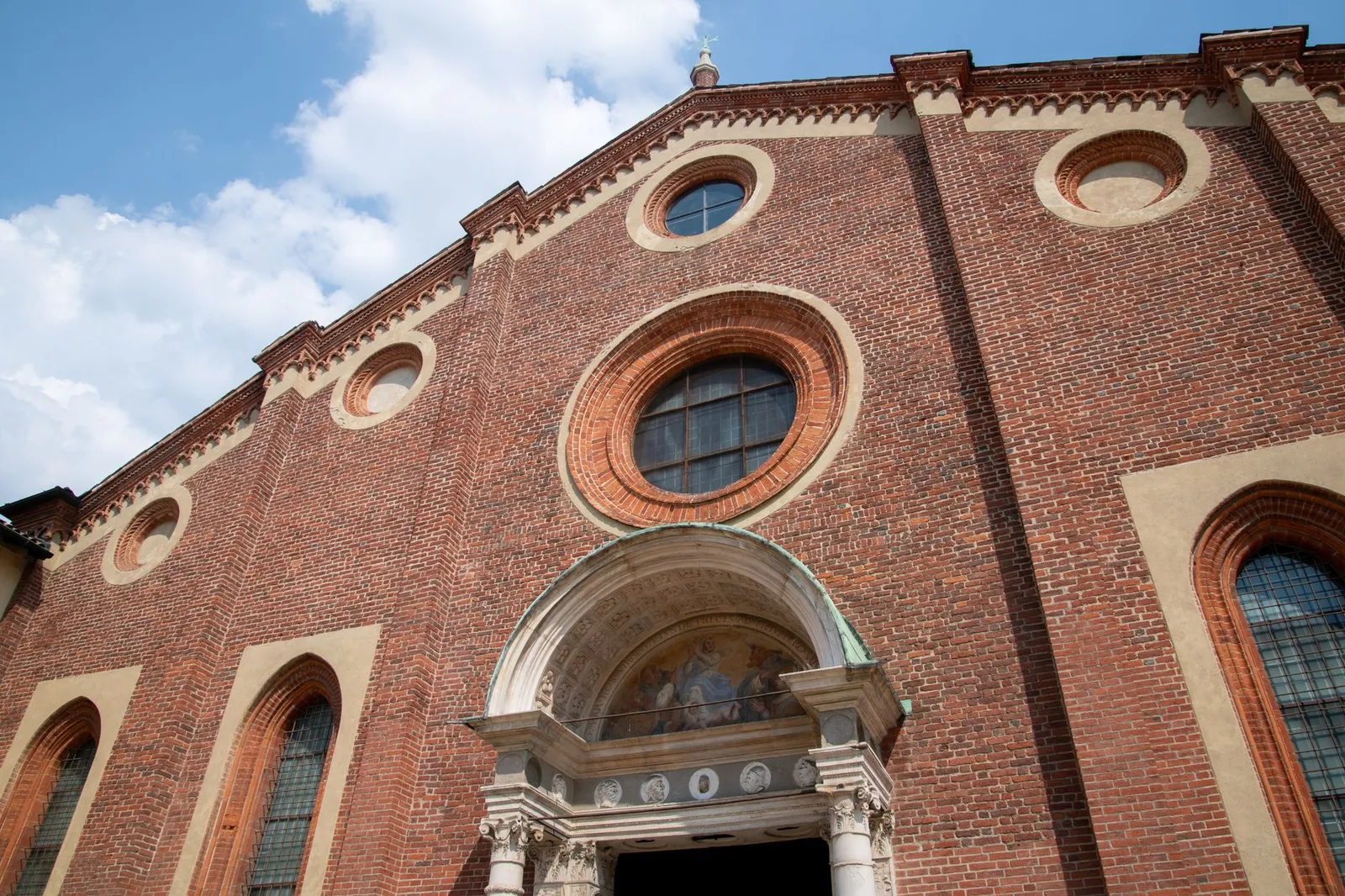 Facade of Santa Maria delle Grazie in Milan showcasing Renaissance architecture.