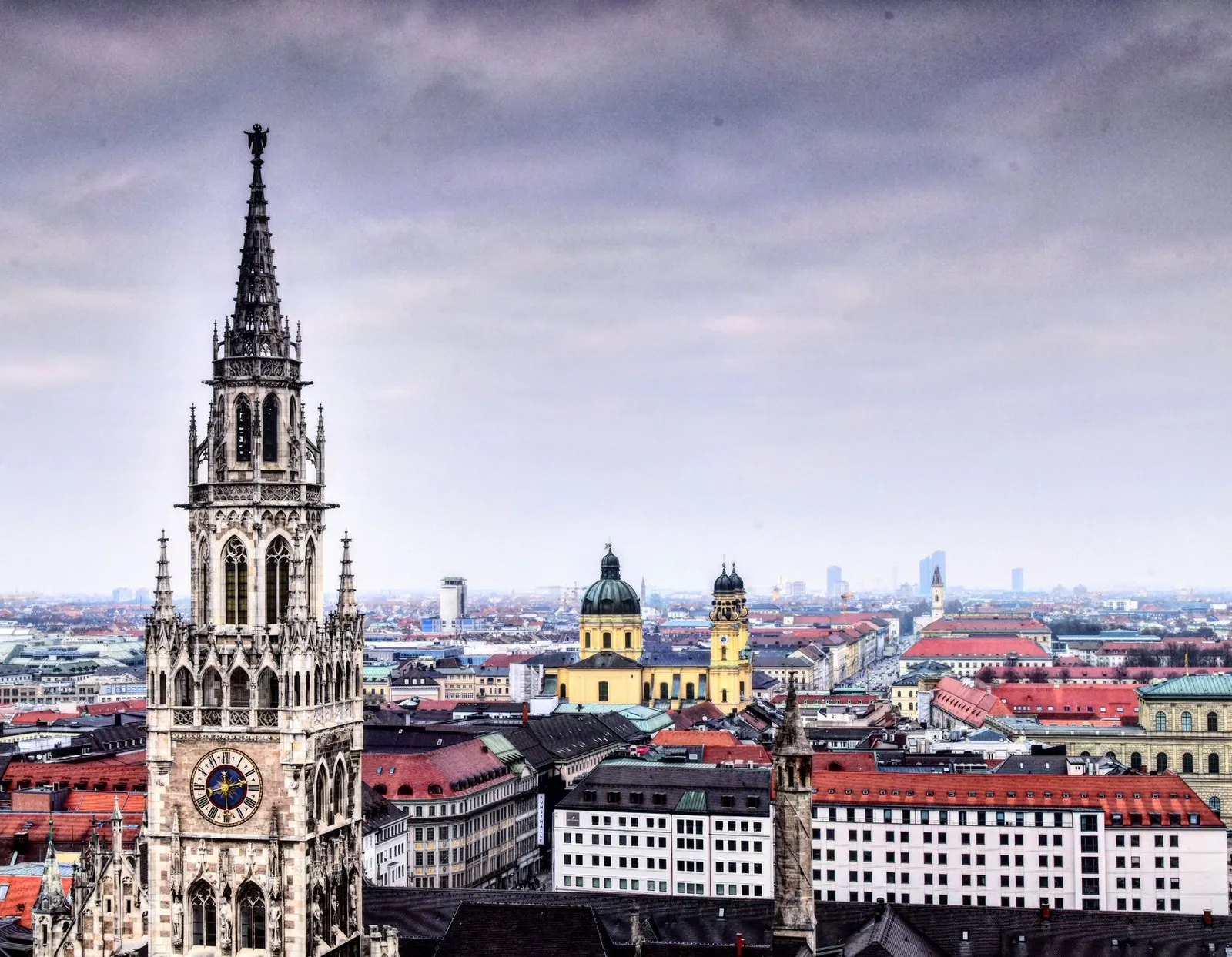 Panoramic view of Munich with prominent clock tower and historic buildings.