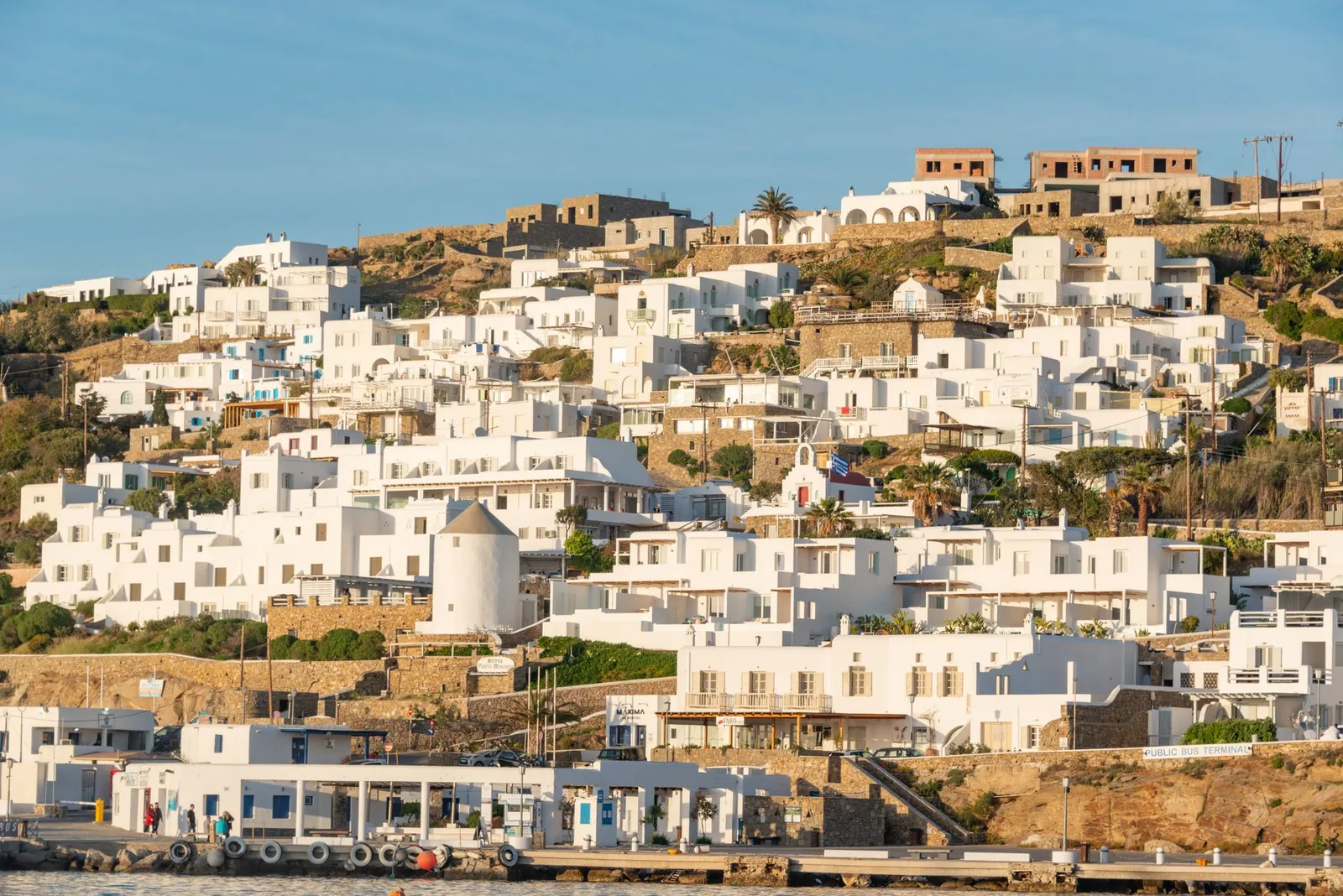Scenic view of traditional white homes on a Greek island during daytime.