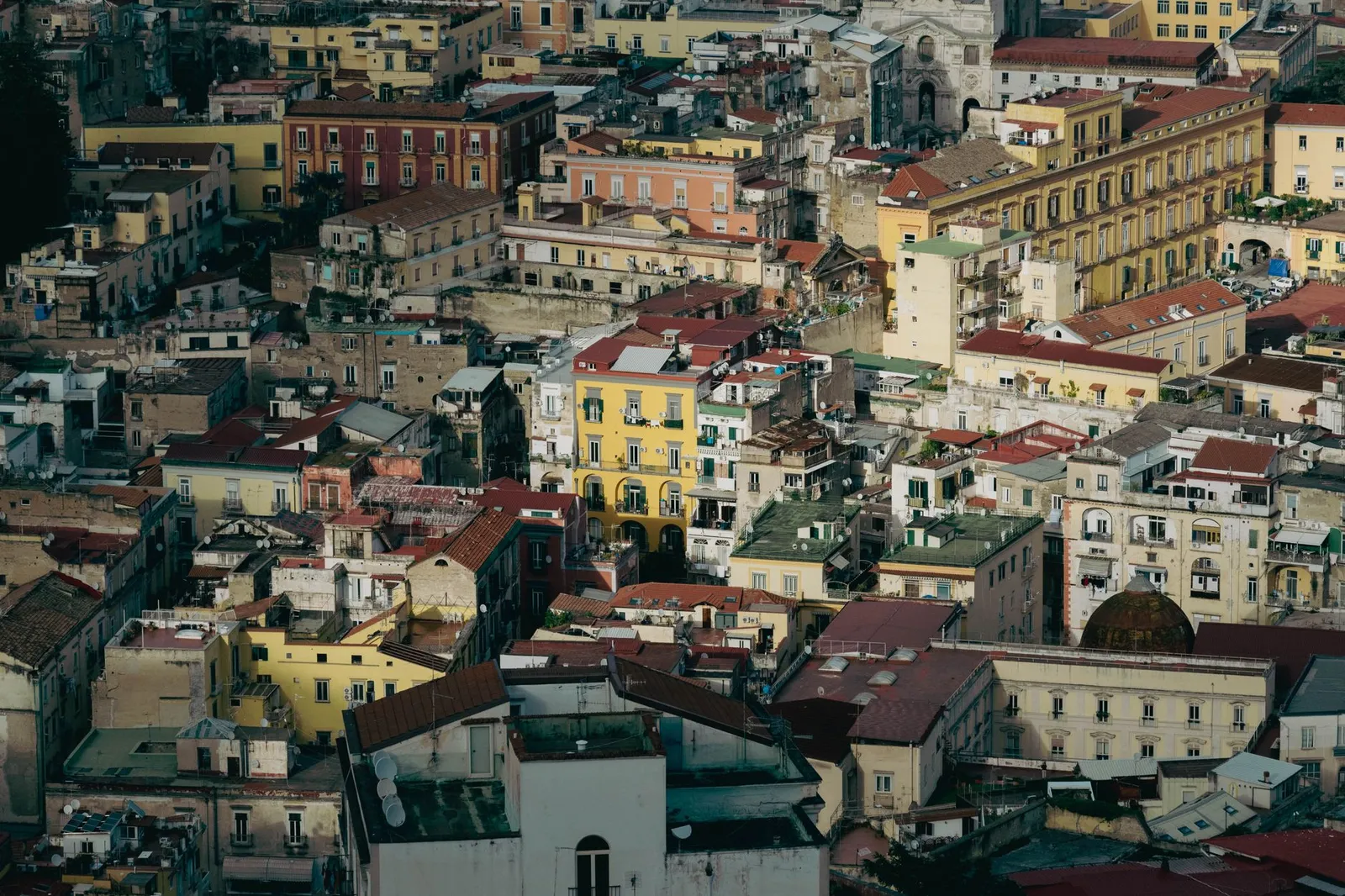 Aerial view of Naples' vibrant architectural landscape, showcasing historic Mediterranean buildings.