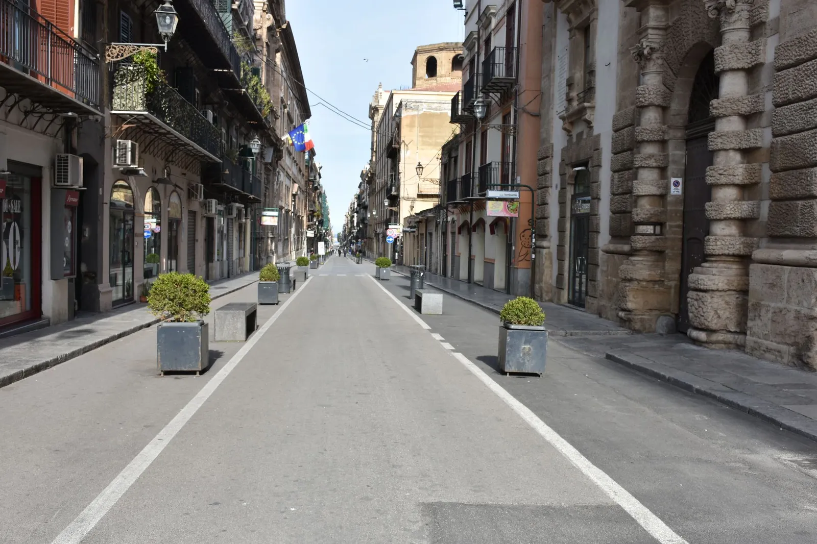 A serene, empty street in historic Palermo showcasing classic architecture and vibrant facades.