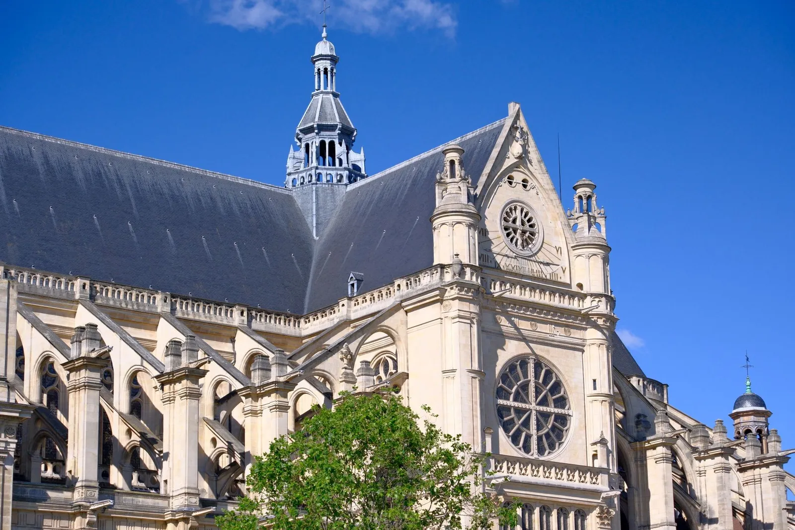 Capture of the Saint-Eustache Church in Paris, showcasing its stunning Gothic architecture against a vibrant blue sky.