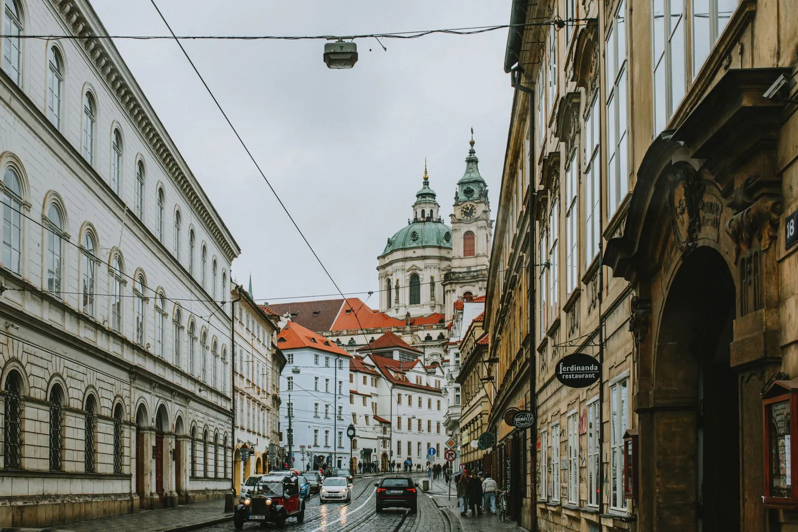 Charming view of historic buildings and St. Nicholas Church in Prague's Malá Strana district.