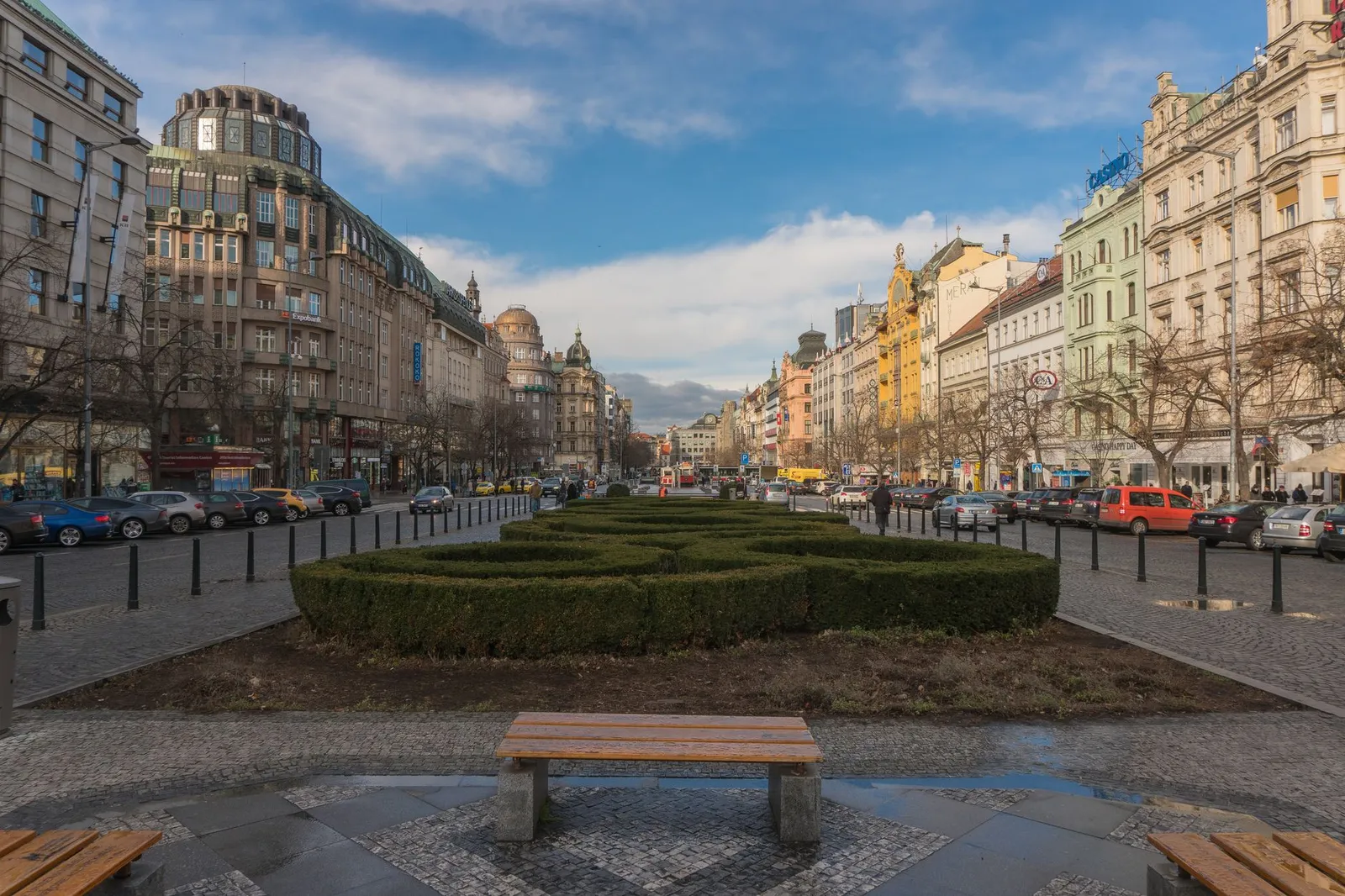 Explore the vibrant cityscape of Wenceslas Square in Prague, showcasing historic architecture and bustling urban life.