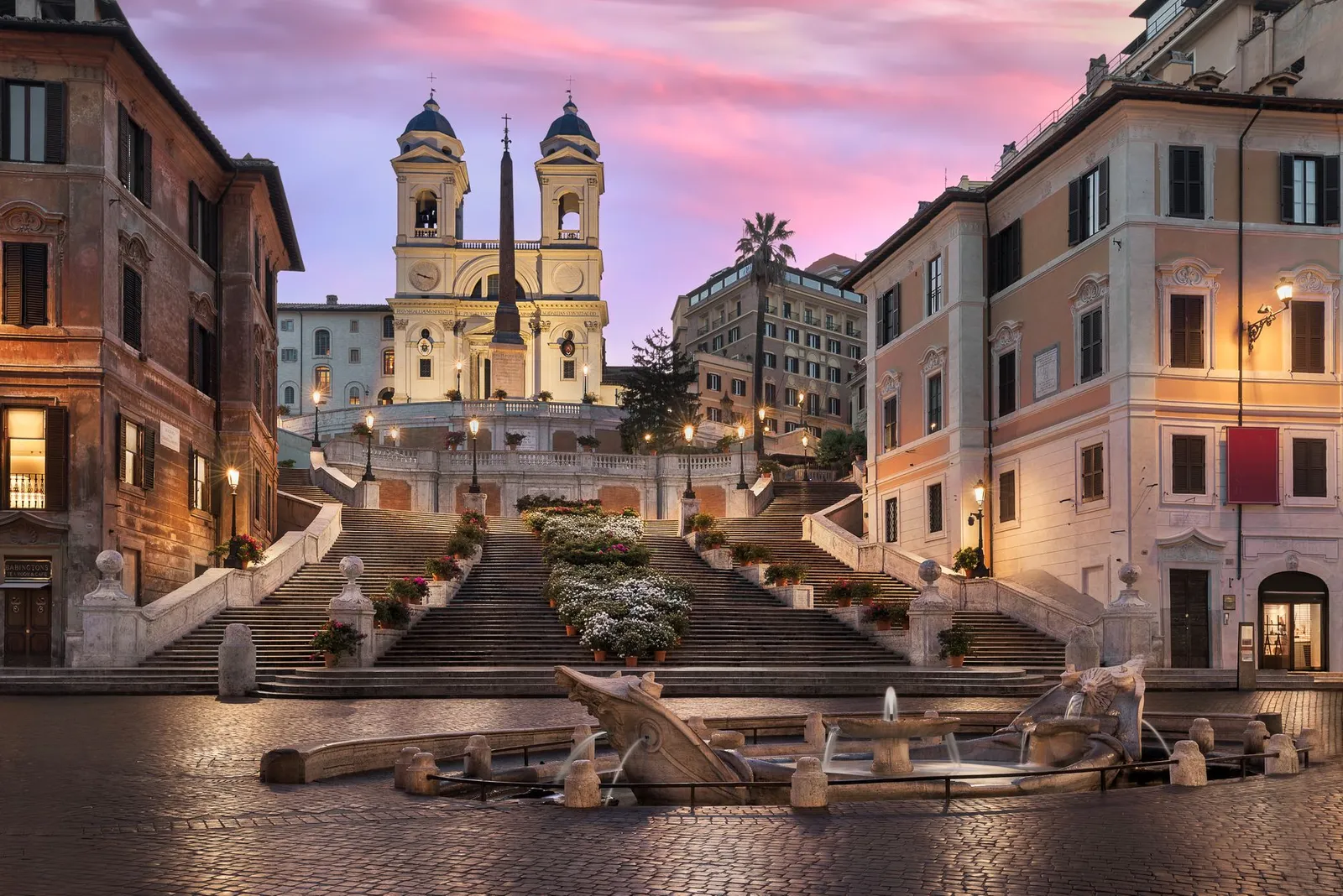 Captivating view of the Spanish Steps and Trinità dei Monti at sunset in Rome, Italy.