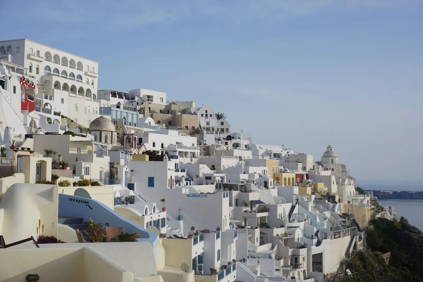 Scenic view of Santorini's whitewashed buildings and Aegean Sea from Thera, Greece.