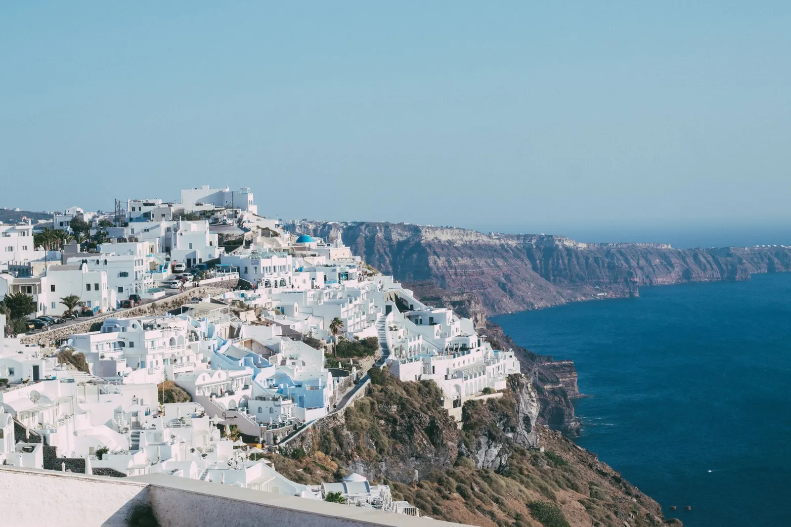 Explore the iconic white-washed architecture and breathtaking ocean views of Santorini's cliffside.