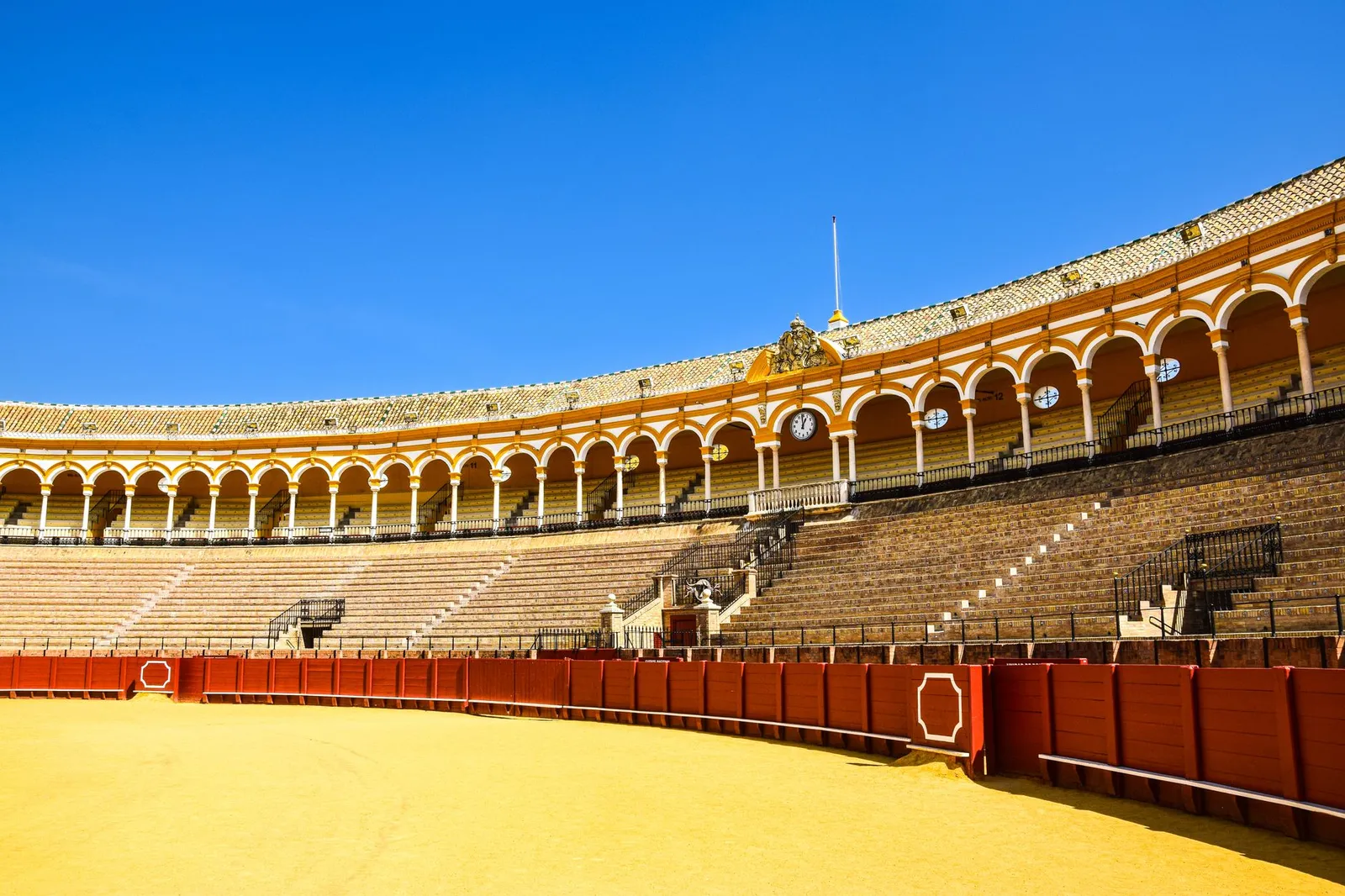 Explore the iconic Plaza de Toros with its stunning architecture in Seville, Spain.