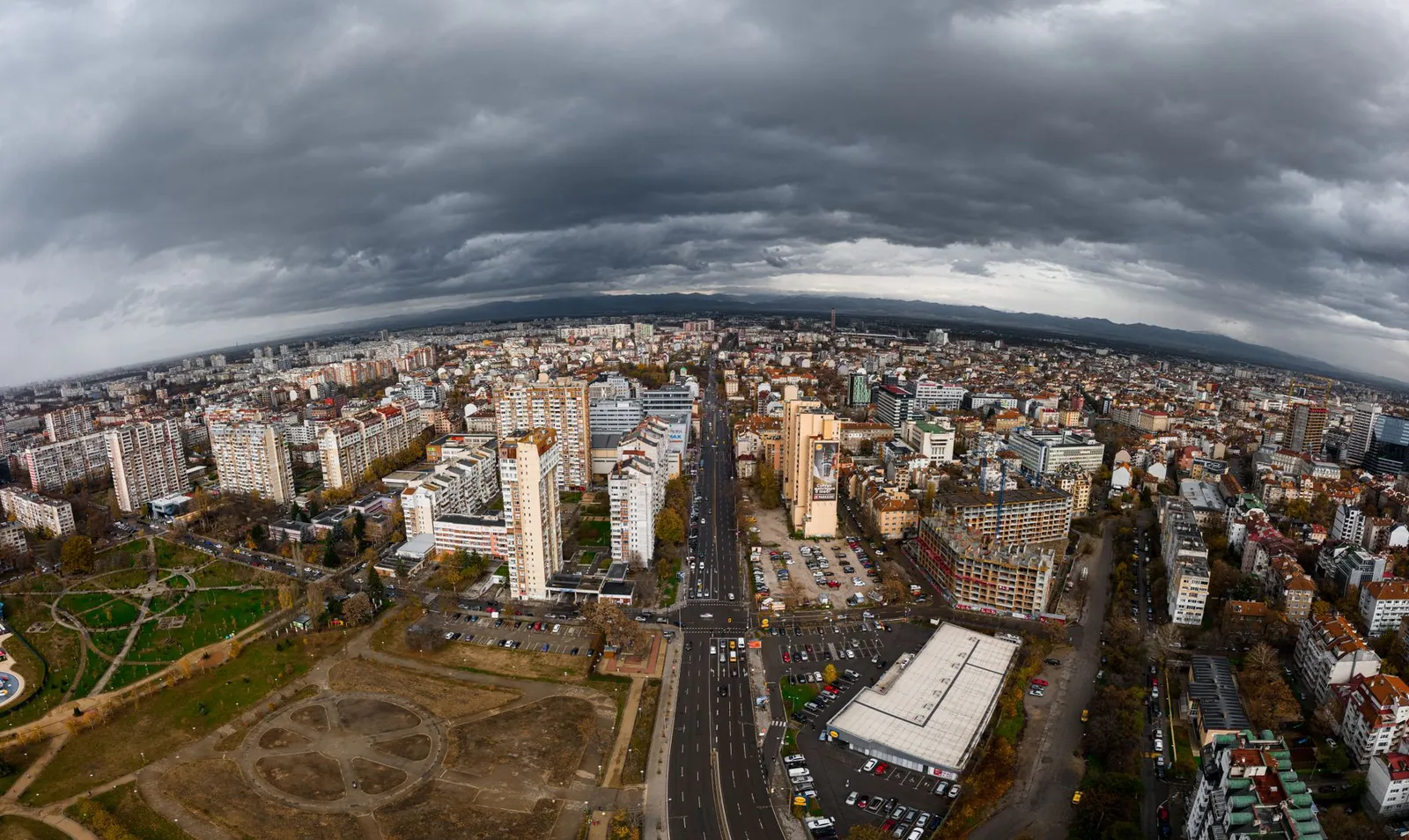 Dramatic aerial view of Sofia, Bulgaria showcasing urban architecture beneath cloudy skies.