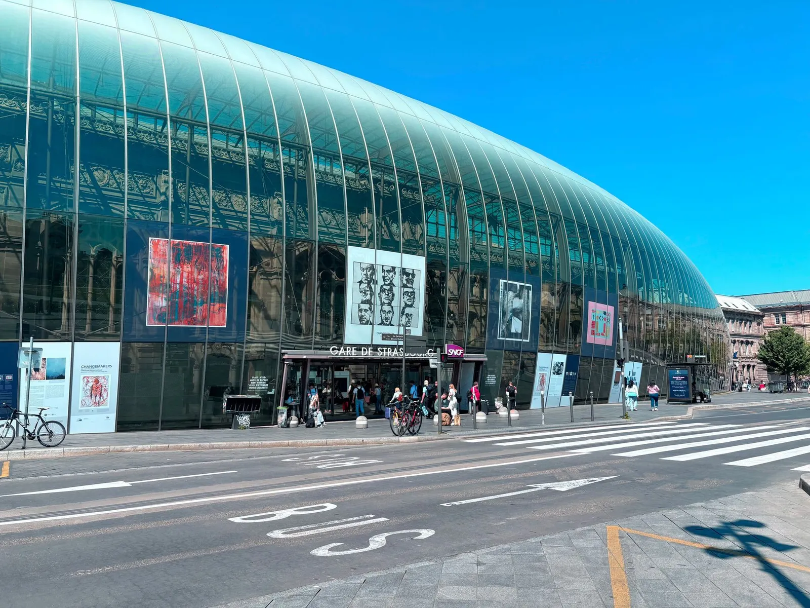 Contemporary design of Gare de Strasbourg with glass facade and vibrant art displays.