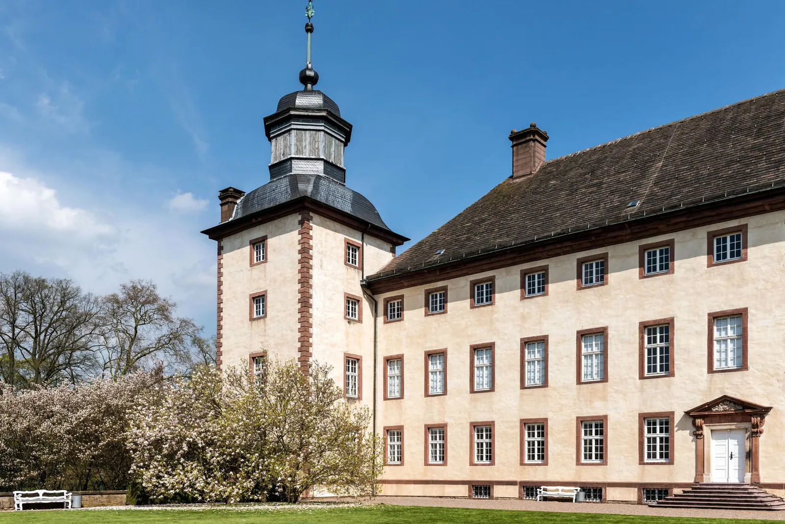 Historic baroque mansion in Höxter, Germany, showcasing classic architecture in spring daylight.