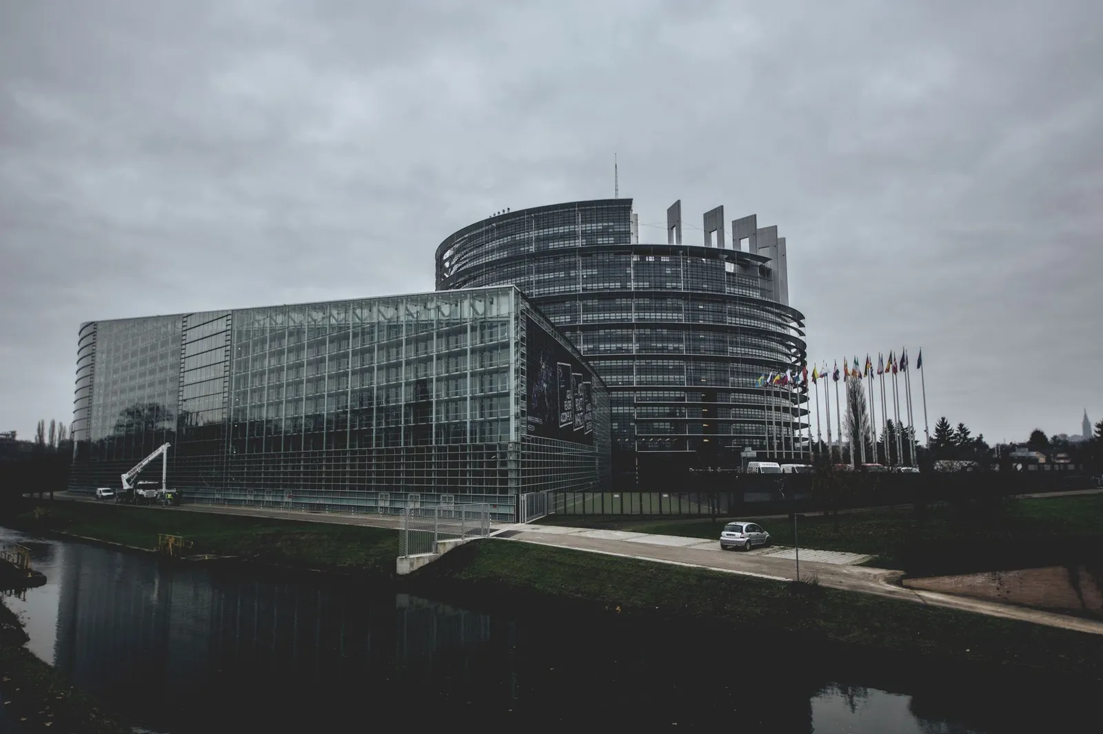Modern architecture of the European Parliament in Strasbourg on a cloudy day.