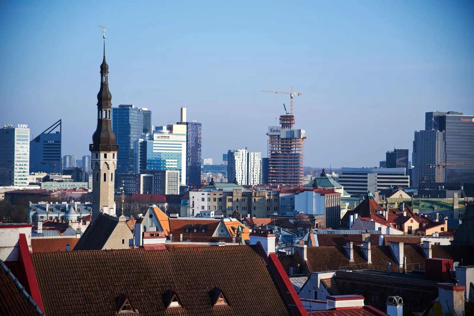 A stunning aerial view of Tallinn's historic and modern skyline with red rooftops and skyscrapers.